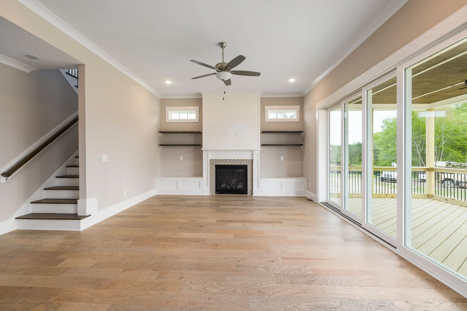 Wide-plank wood flooring running through a bright, open living room