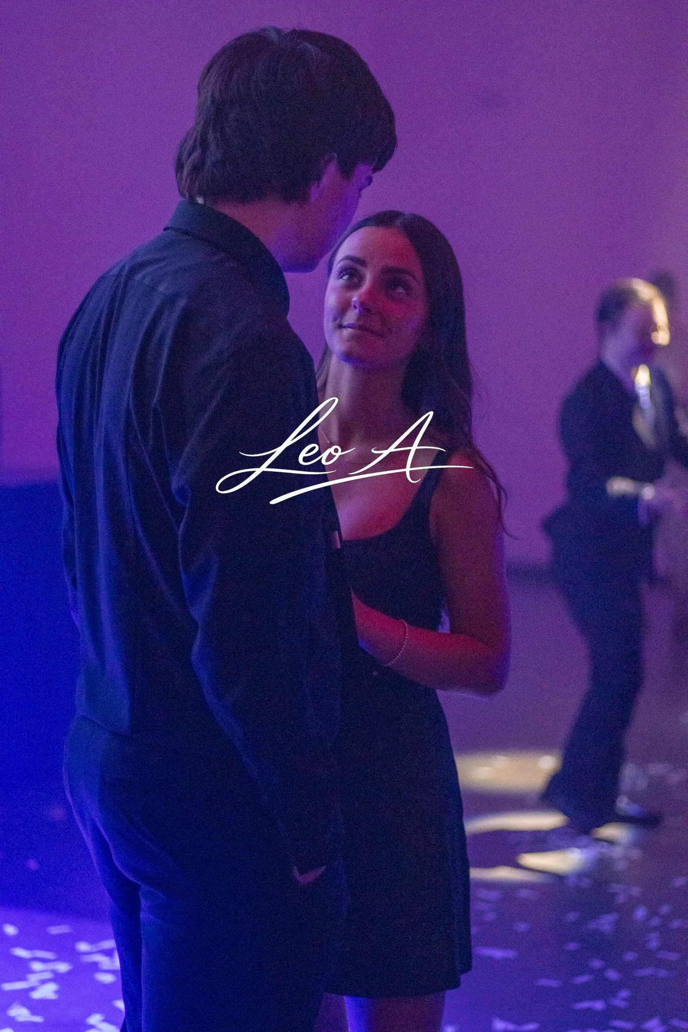 Portrait of a young man and young woman at a high school dance by photographer Leo Assalian.