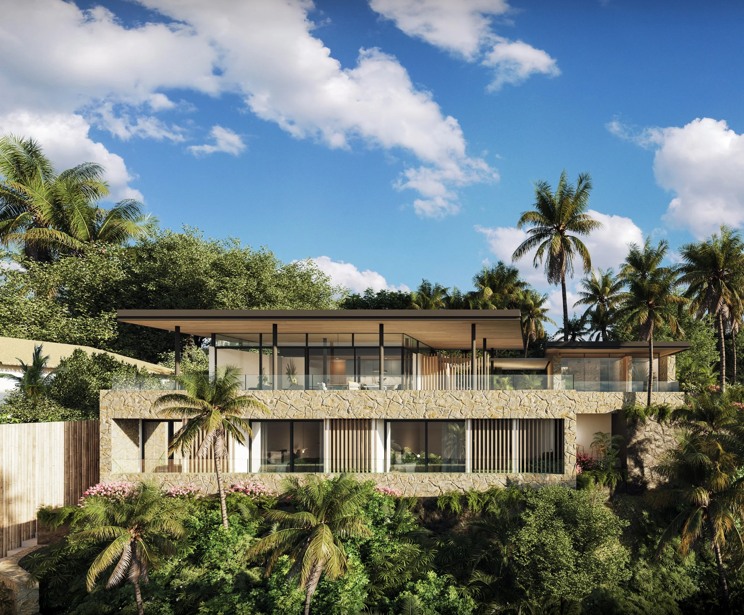 Casa moderna de múltiples niveles rodeada de palmeras y vegetación, con cielo despejado y nubes blancas.