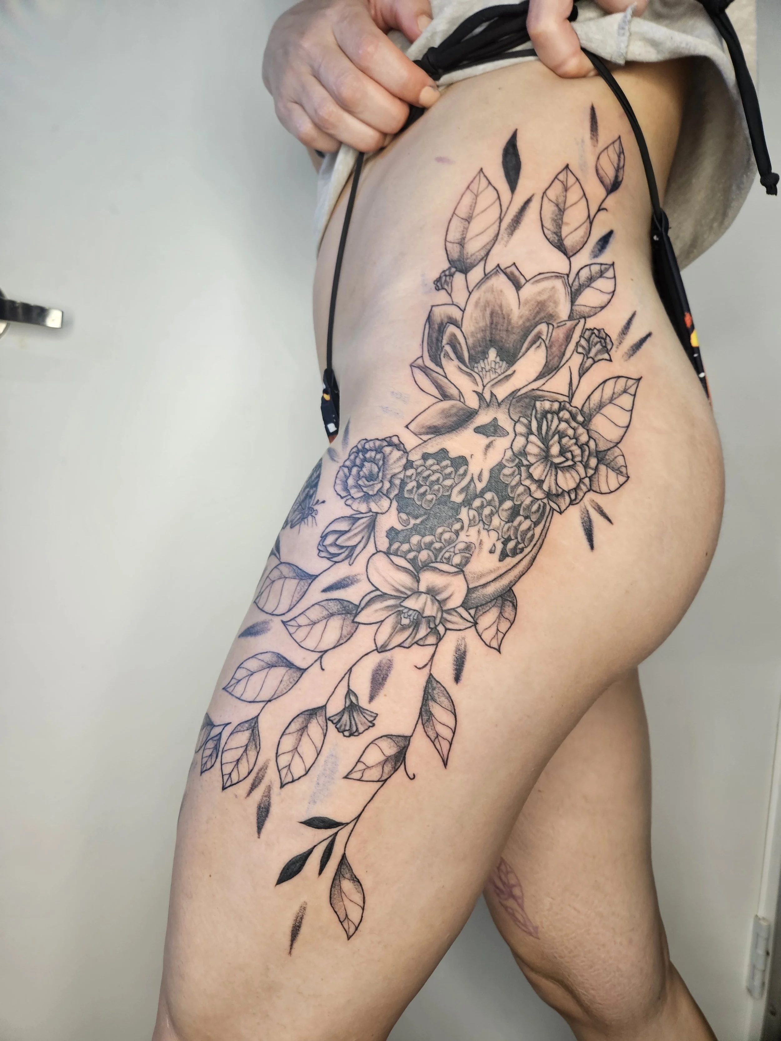 pomegranate and marigolds on thigh