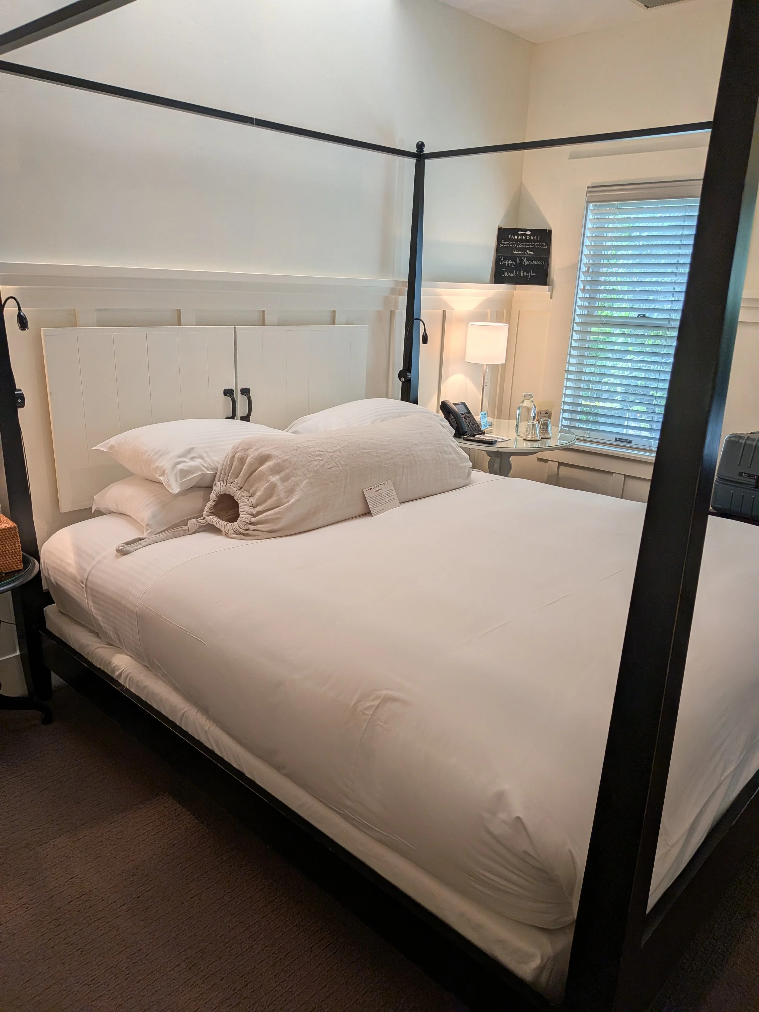 A hotel room bed at Farmhouse Inn in Forestville, CA