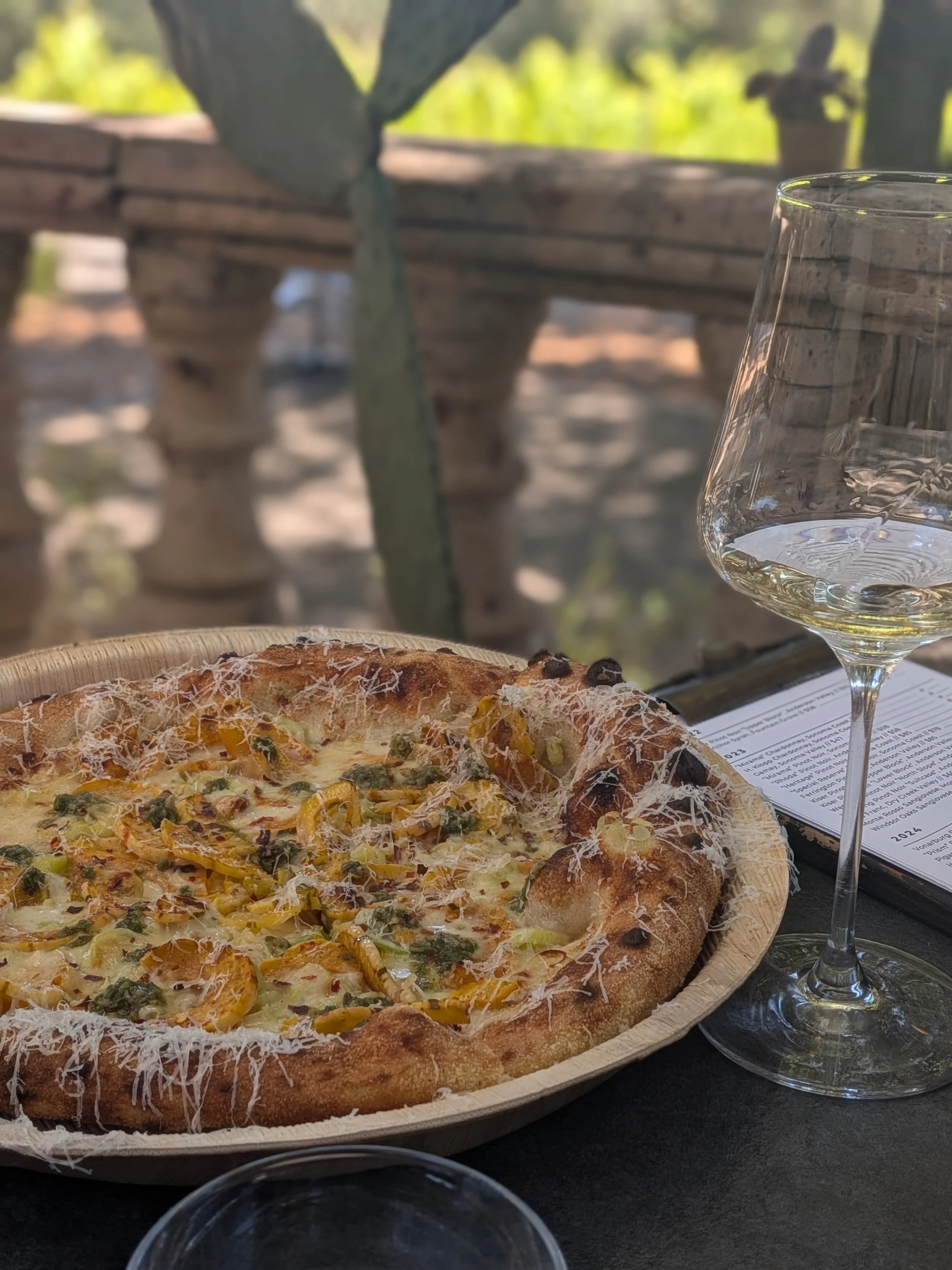 A pizza and wine glass at Reeve Wines in Healdsburg, CA