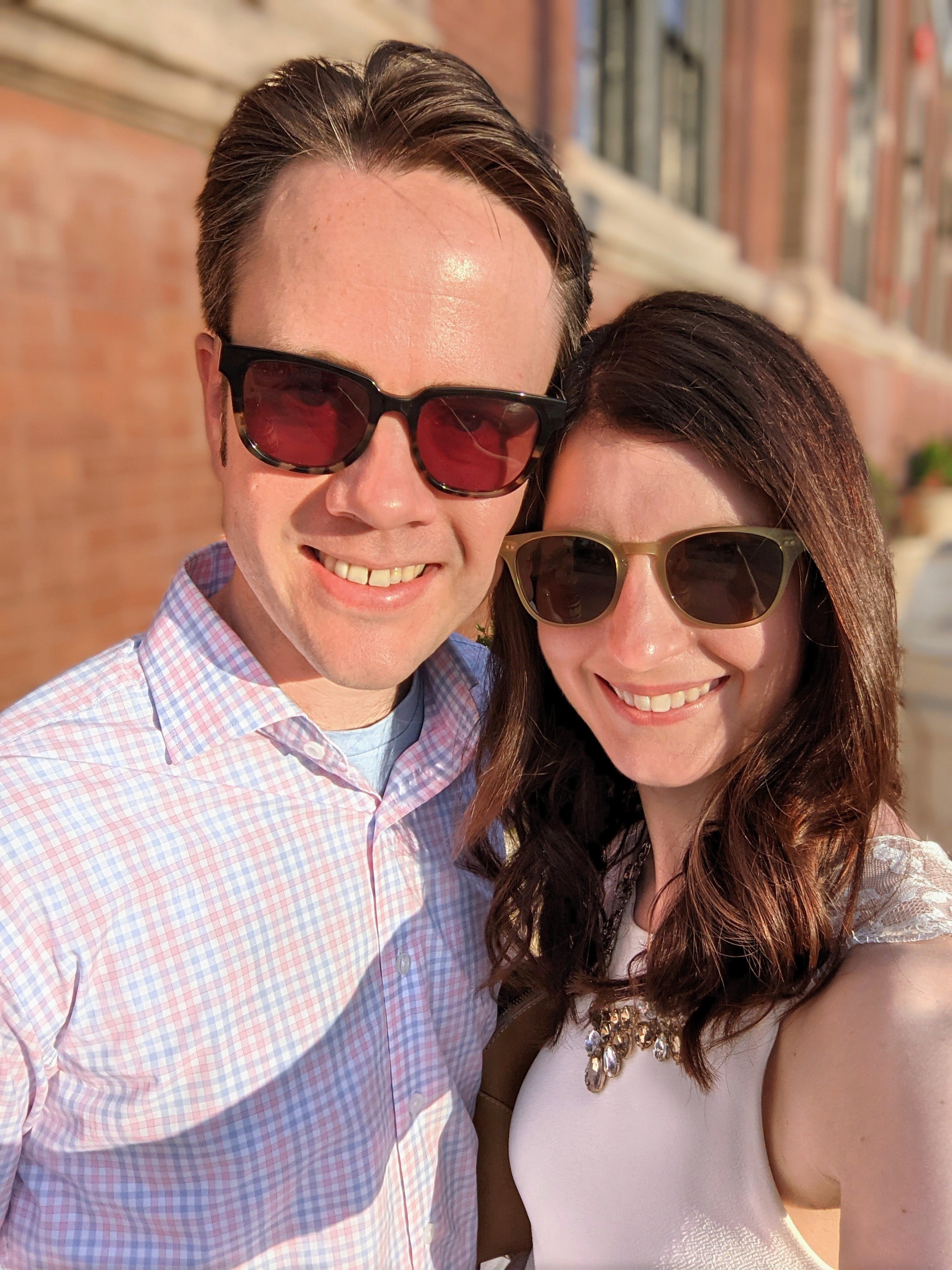 A couple smiling outside of J Rieger &amp; Co distillery in Kansas City