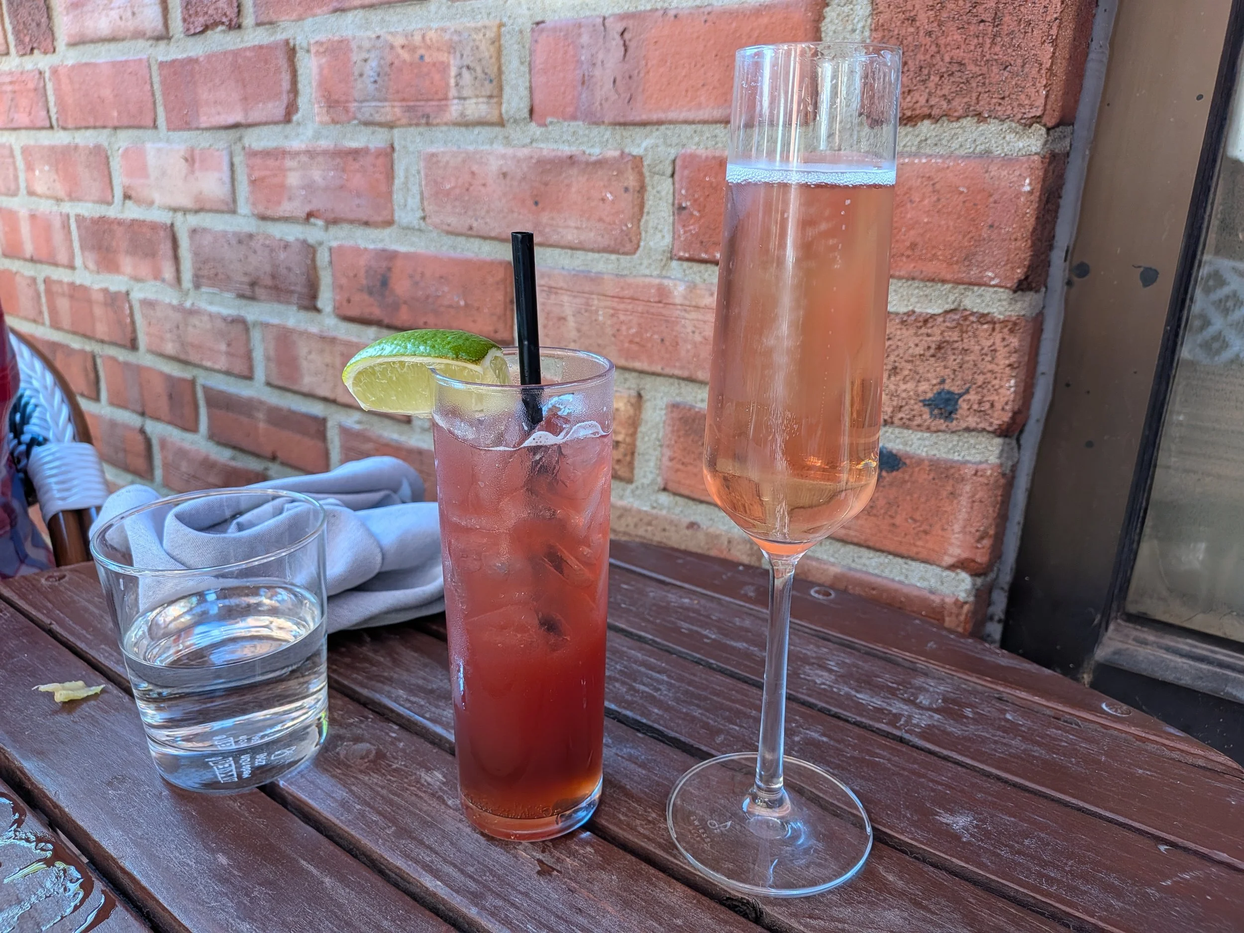 A cocktail and sparkling wine from Le Champion in Kansas City