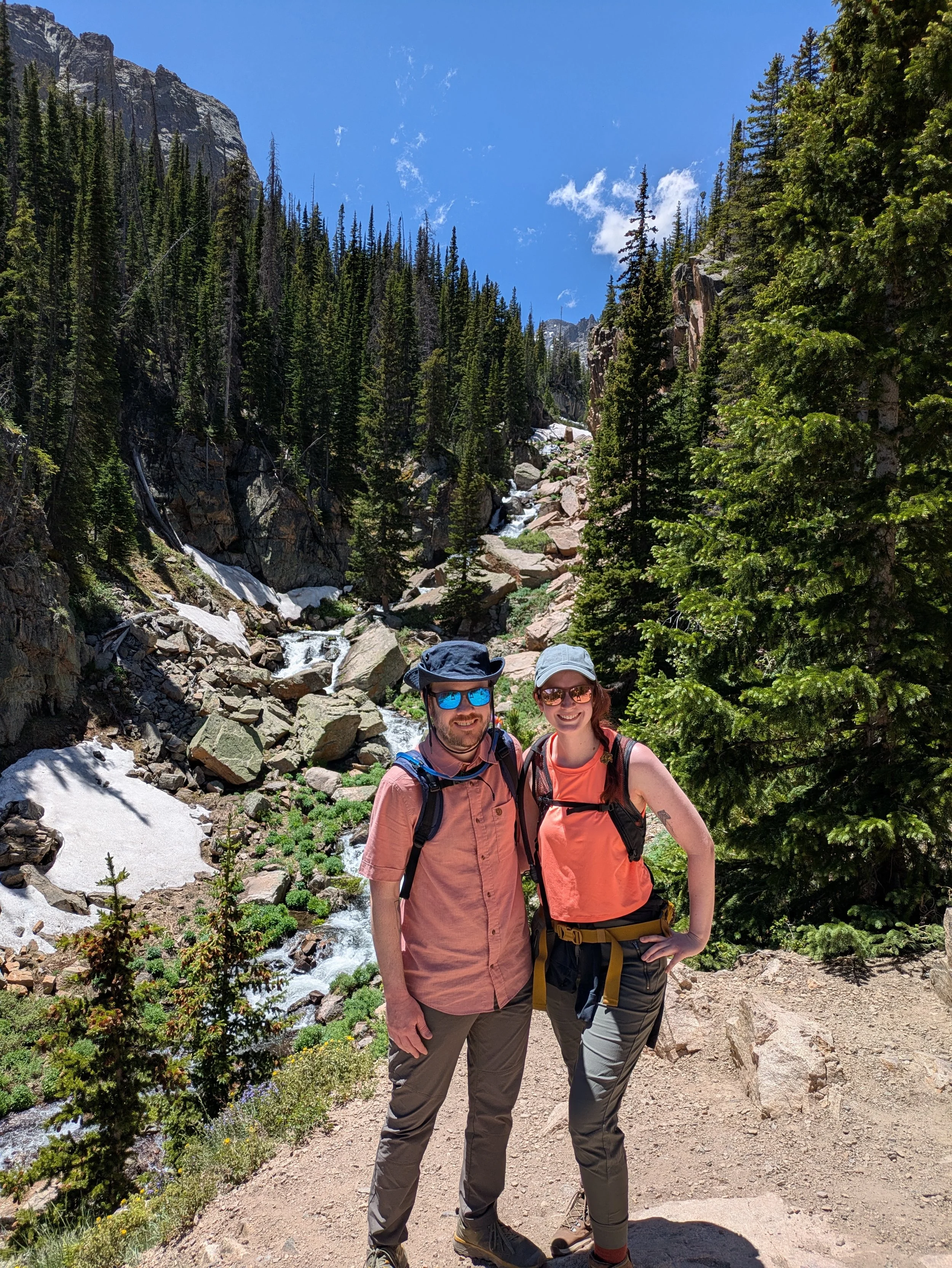 A couple post while hiking in Rocky Mountain National Park