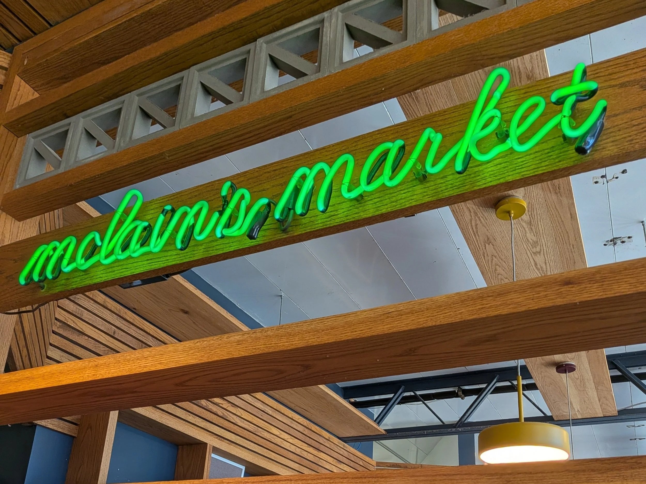 Neon green sign for mclain's market