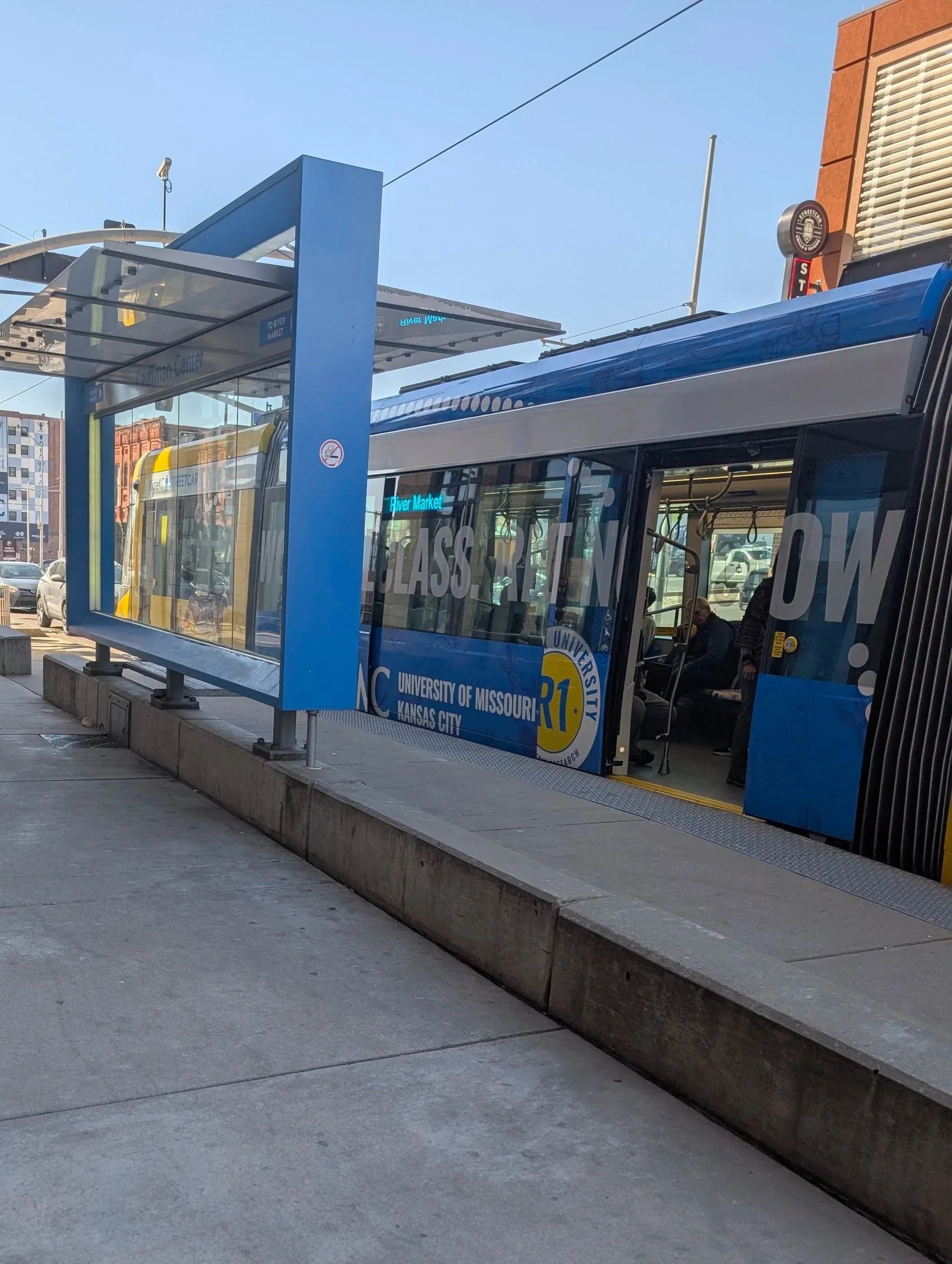 The Kansas City Streetcar stopped at a streetcar stop.