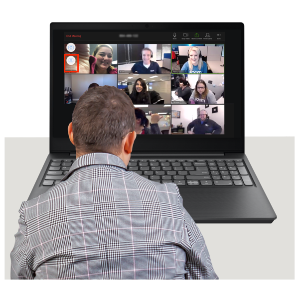 Person participating in a virtual meeting on a laptop with multiple smiling faces visible on the screen.