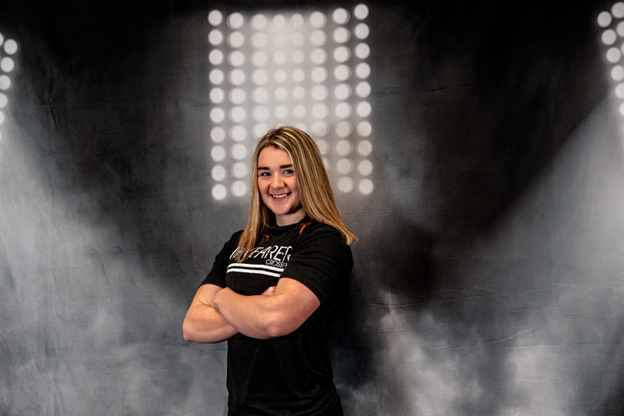 Briauna Creehan with black Wayfarer CrossFit shirt on a smoke lights background. 