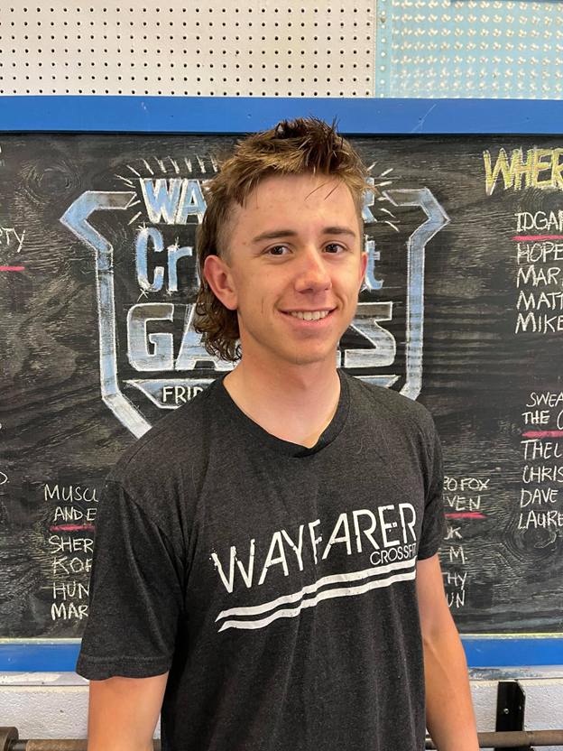 Brent Creehan standing in front of a chalkboard.