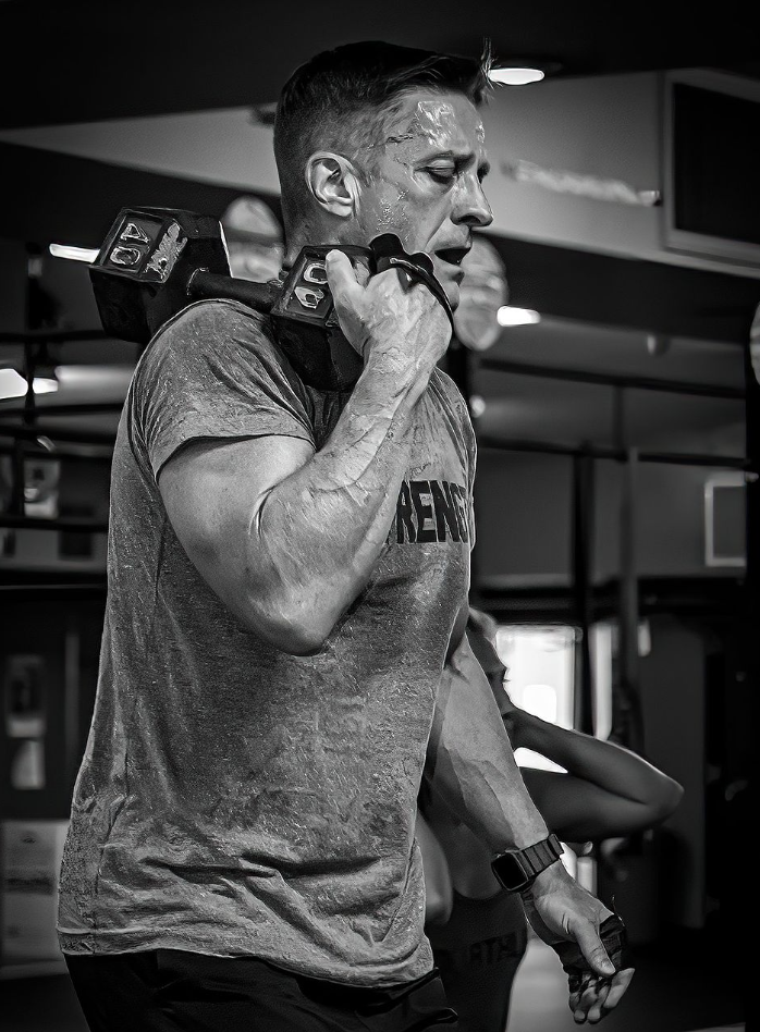 Dave Car carrying a a 40lb dumbbell.