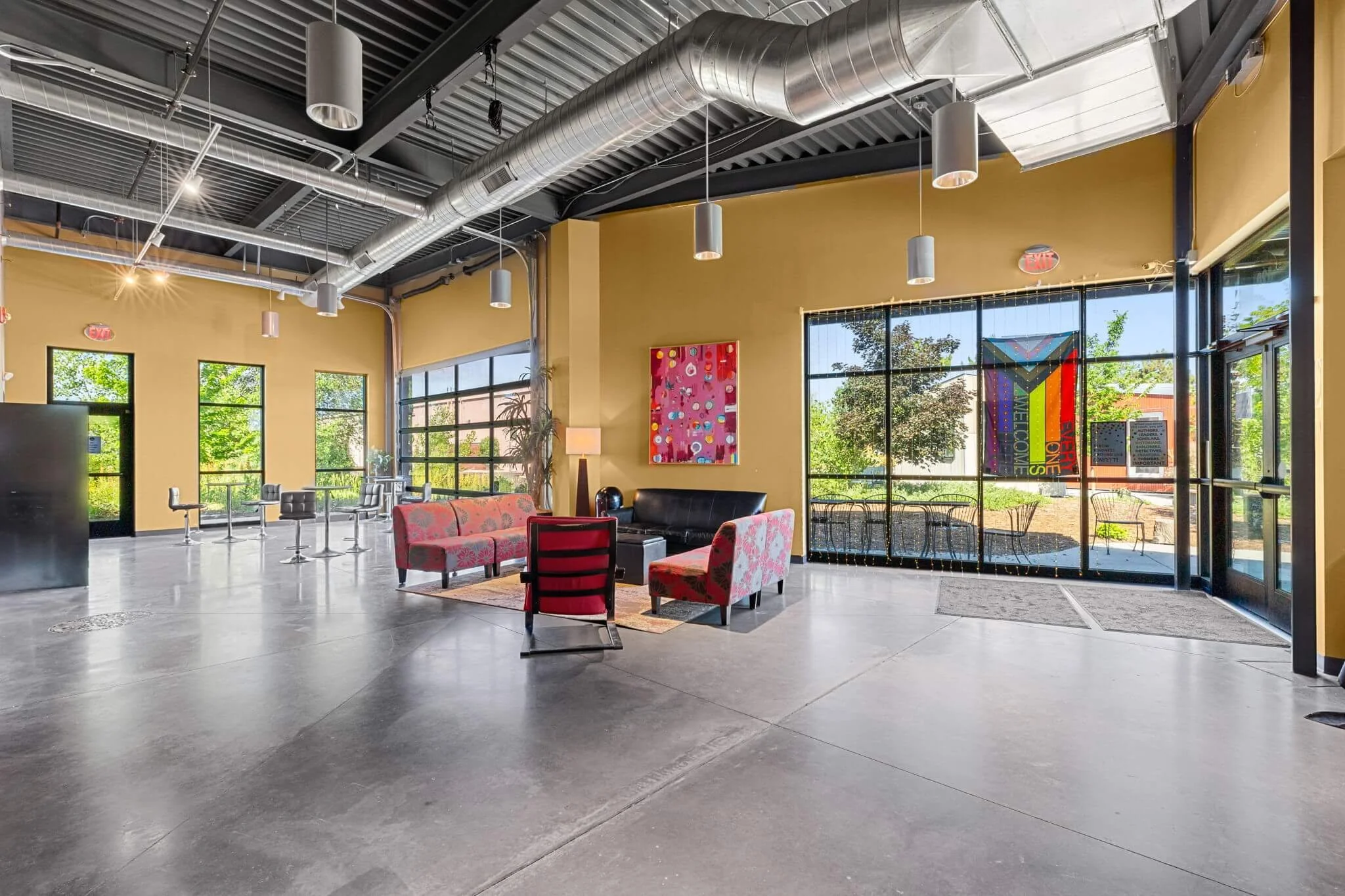 Seating area with couches and large windows.