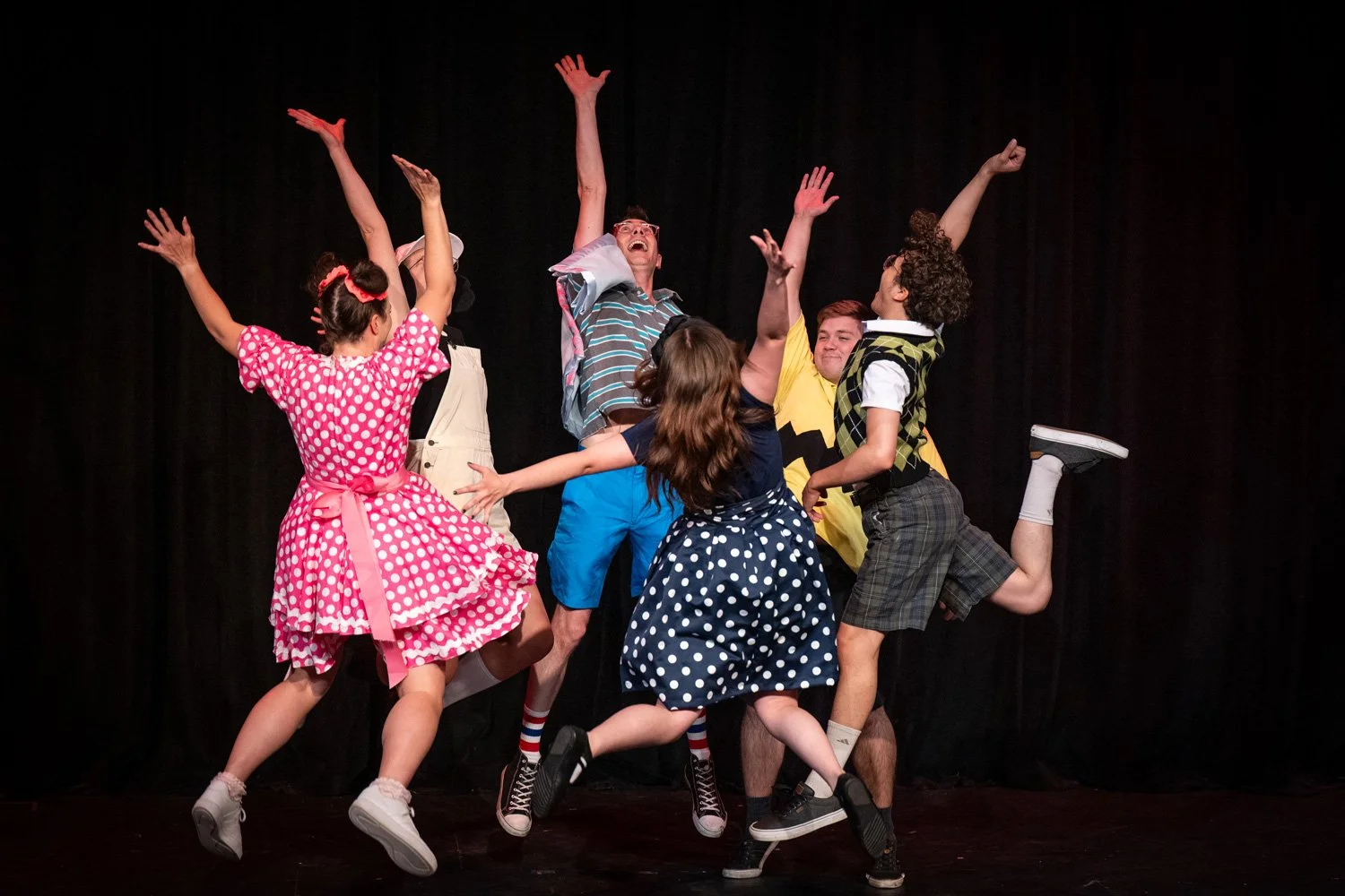 A group of children jumping in the air.