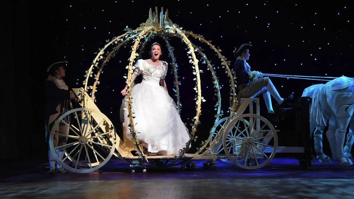 Cinderella in her carriage on stage.