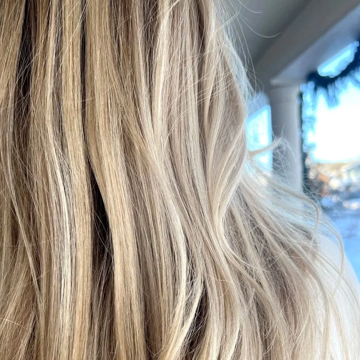 Close-up of blonde hair with wavy texture.