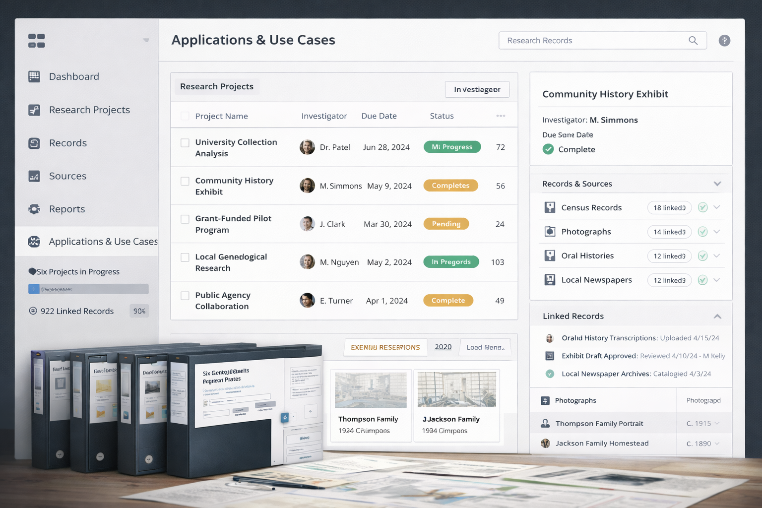 Computer screen showing dashboard for research projects, with project list, statuses, and linked records, in front of physical binders and printed documents.