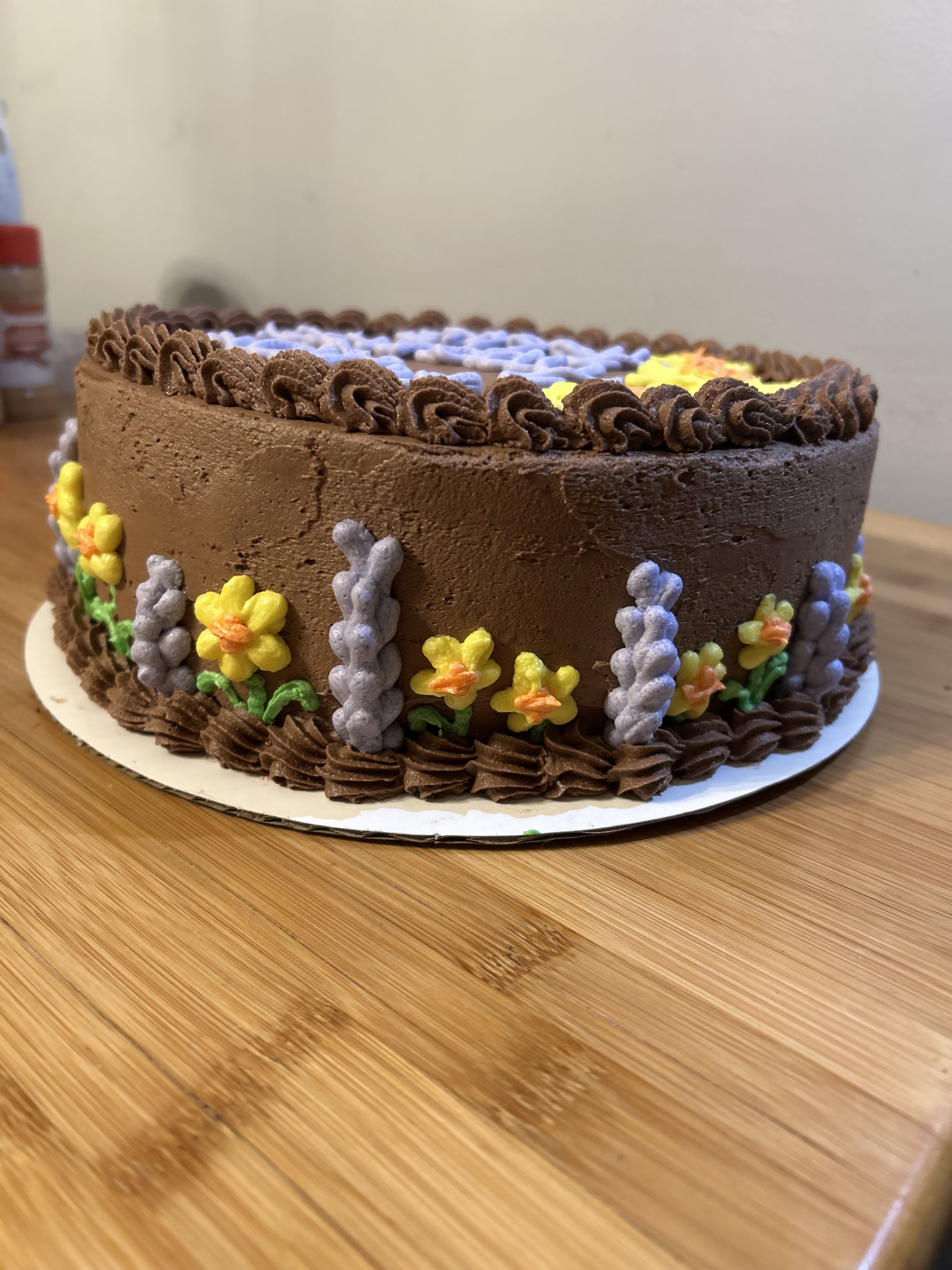 custom chocolate cake w chocolate buttercream and lavender and daffodil decorations