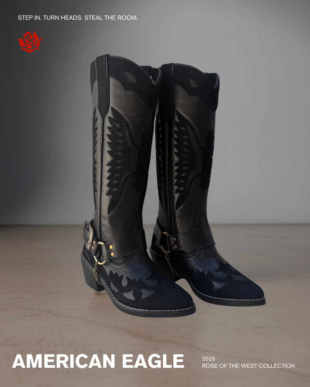 Black knee-high cowboy boots with wing and lightning designs, metal buckles, and chains, placed on a wooden surface against a plain background.