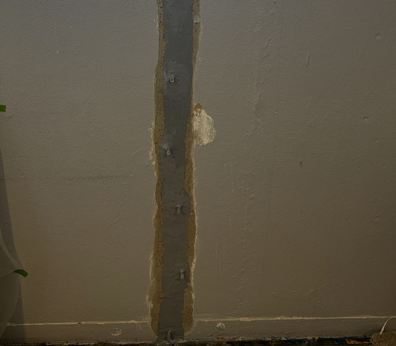 Close-up of a damaged section of ceiling with exposed wiring and insulation.