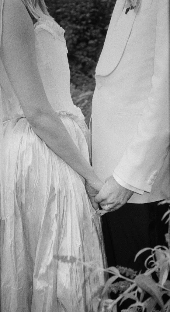 A bride and groom holding hands during a wedding ceremony.