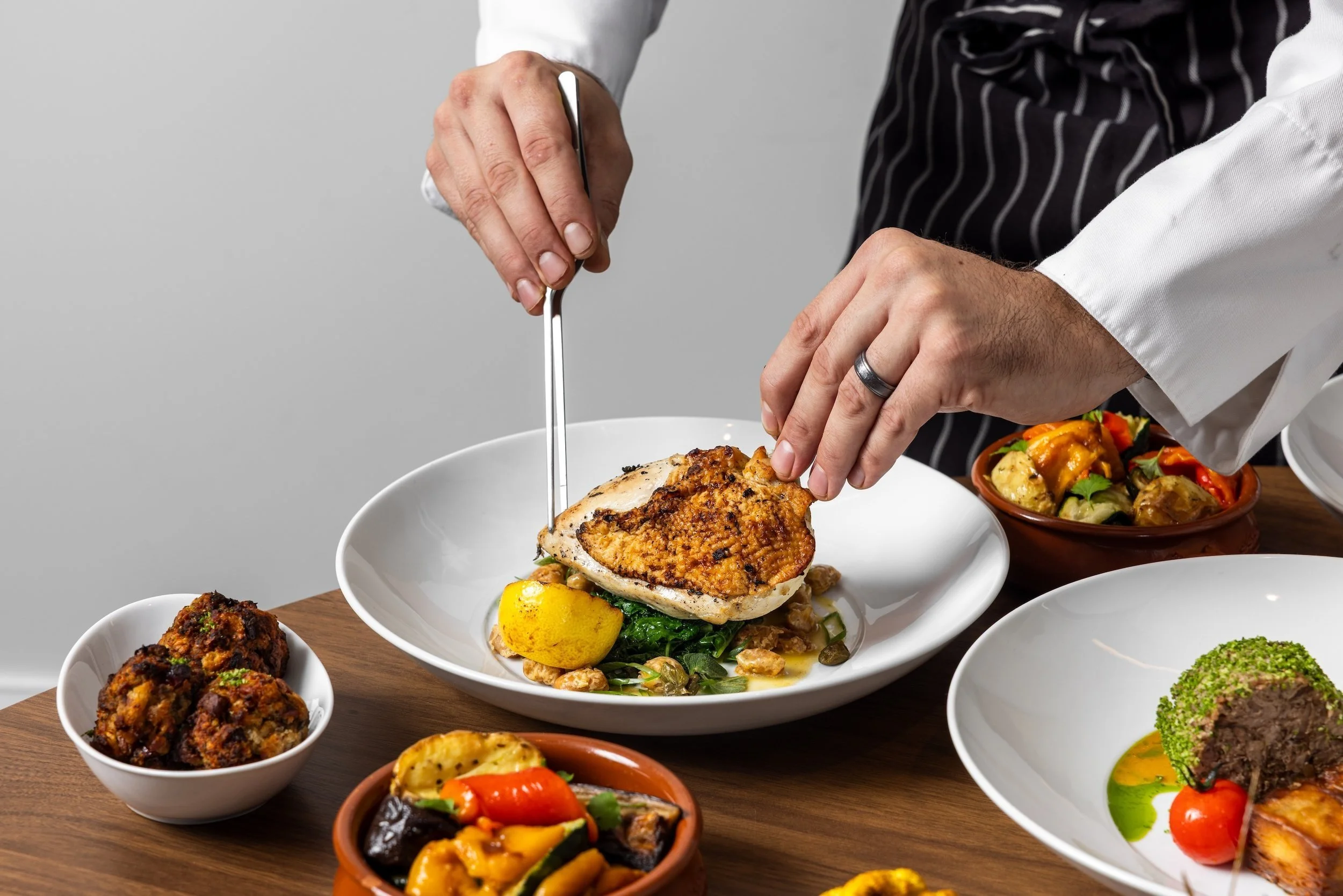 Executive Dining on site is Chef led. Here's an example with our onsite chef garnishing a plated dish.