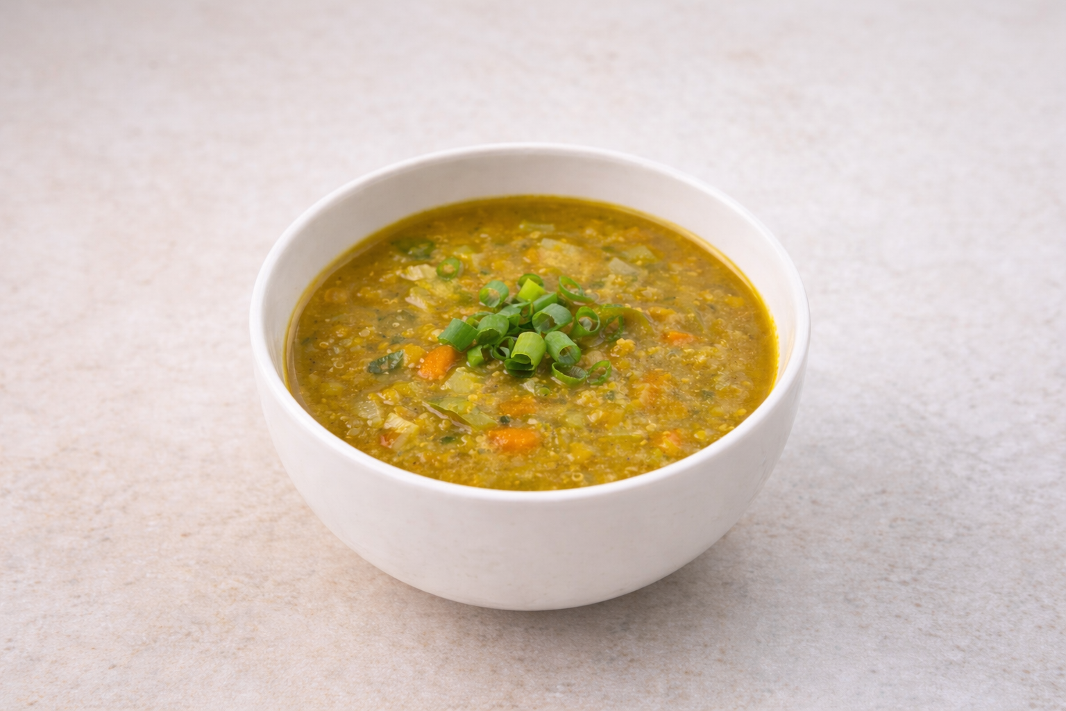 Bowl of vegetable soup garnished with chopped green onions