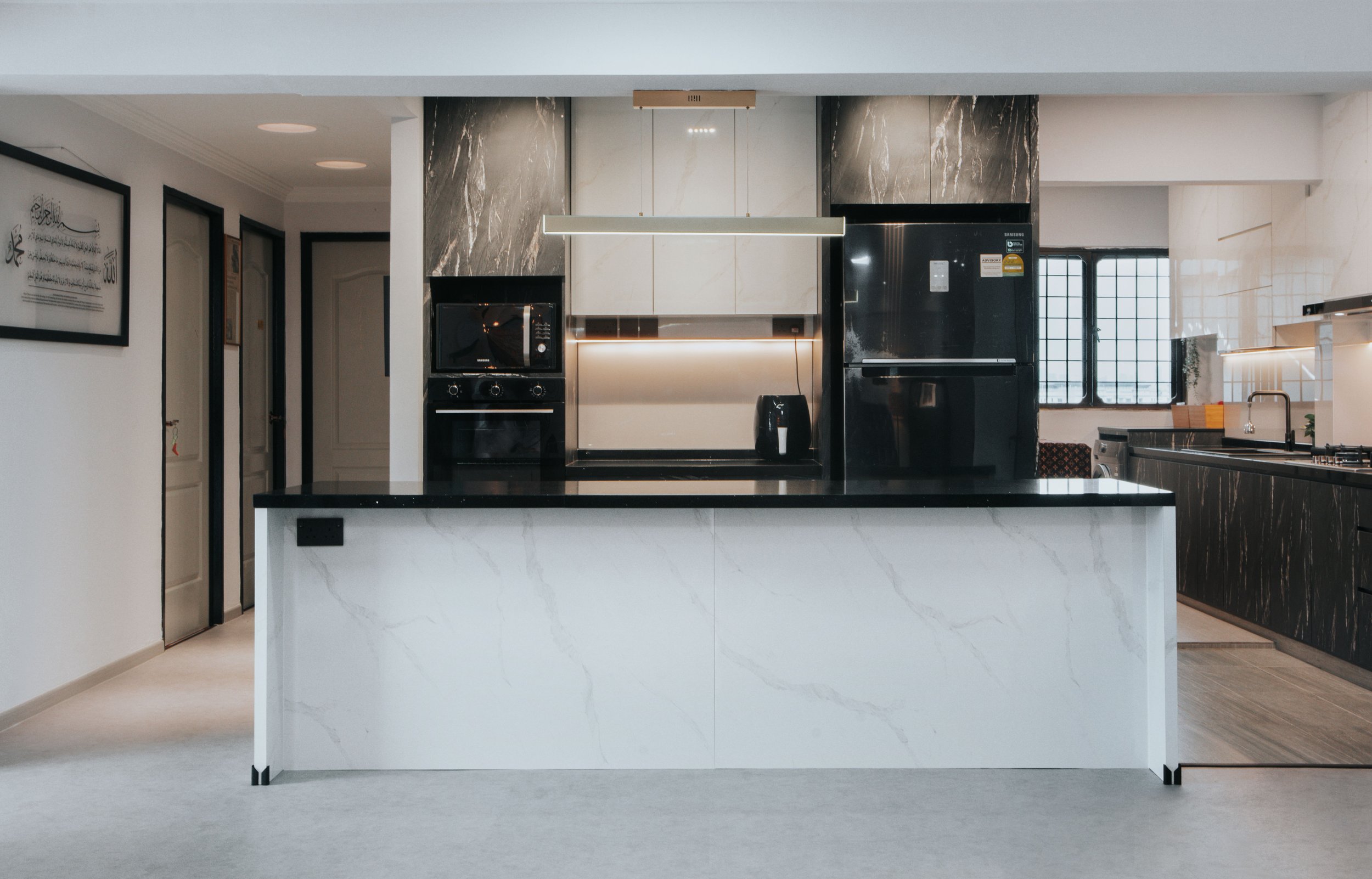 Contemporary kitchen with a black countertop, featuring sleek appliances and modern cabinetry.