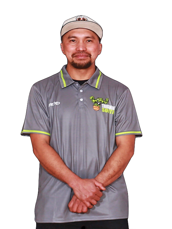 A man wearing a gray polo shirt with the logo 'Trucando South' and a white baseball cap, standing with his hands clasped in front of him against a black background.