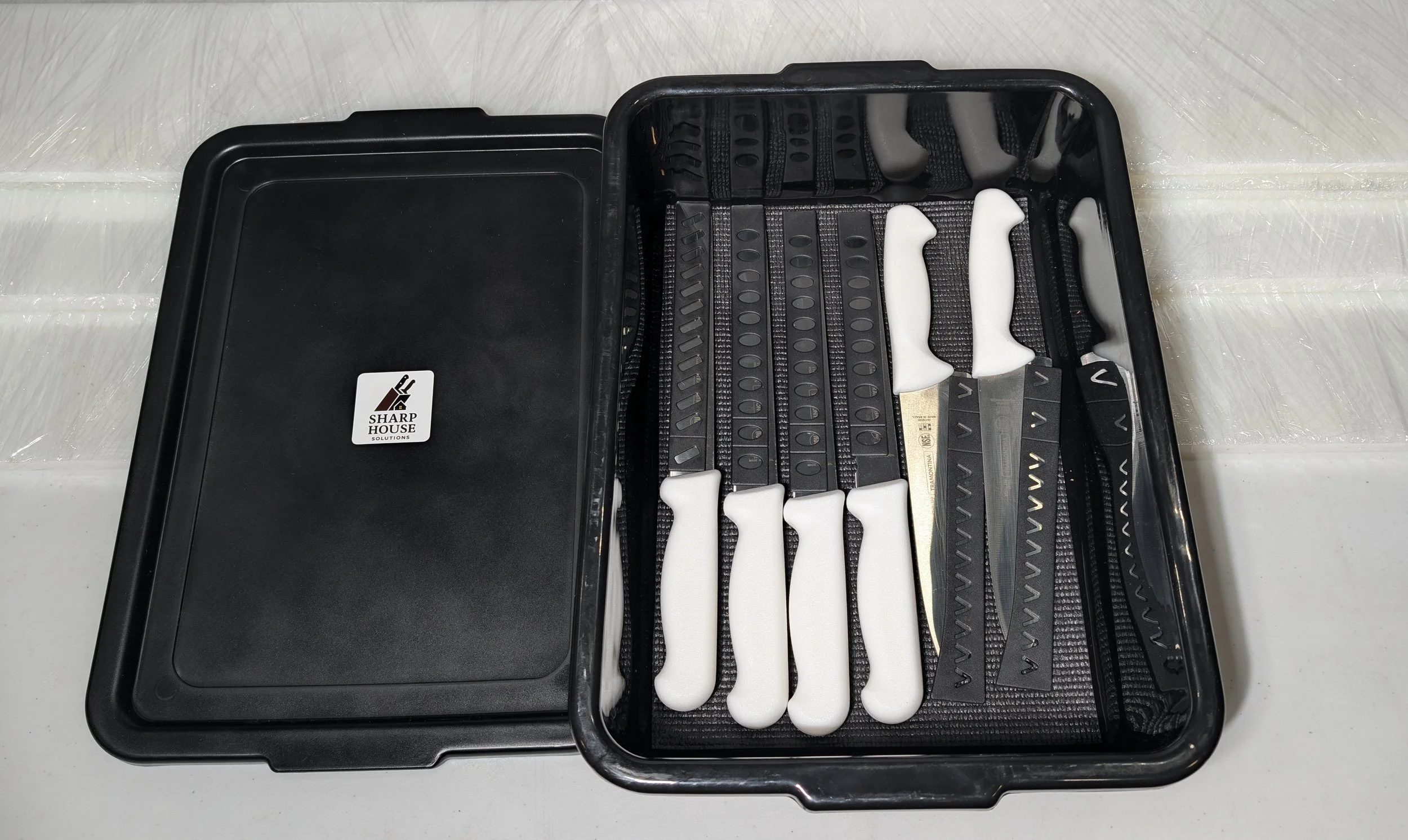 Sharp House commercial Knife Exchange set with white-handled kitchen knives in a black transport case