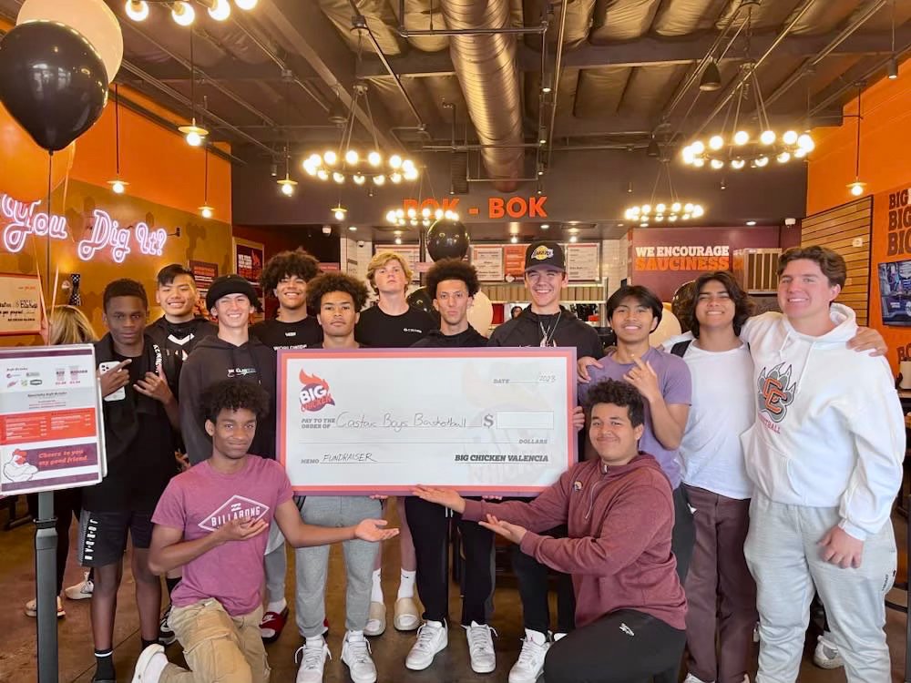Costas Boys Basketball team with oversized check