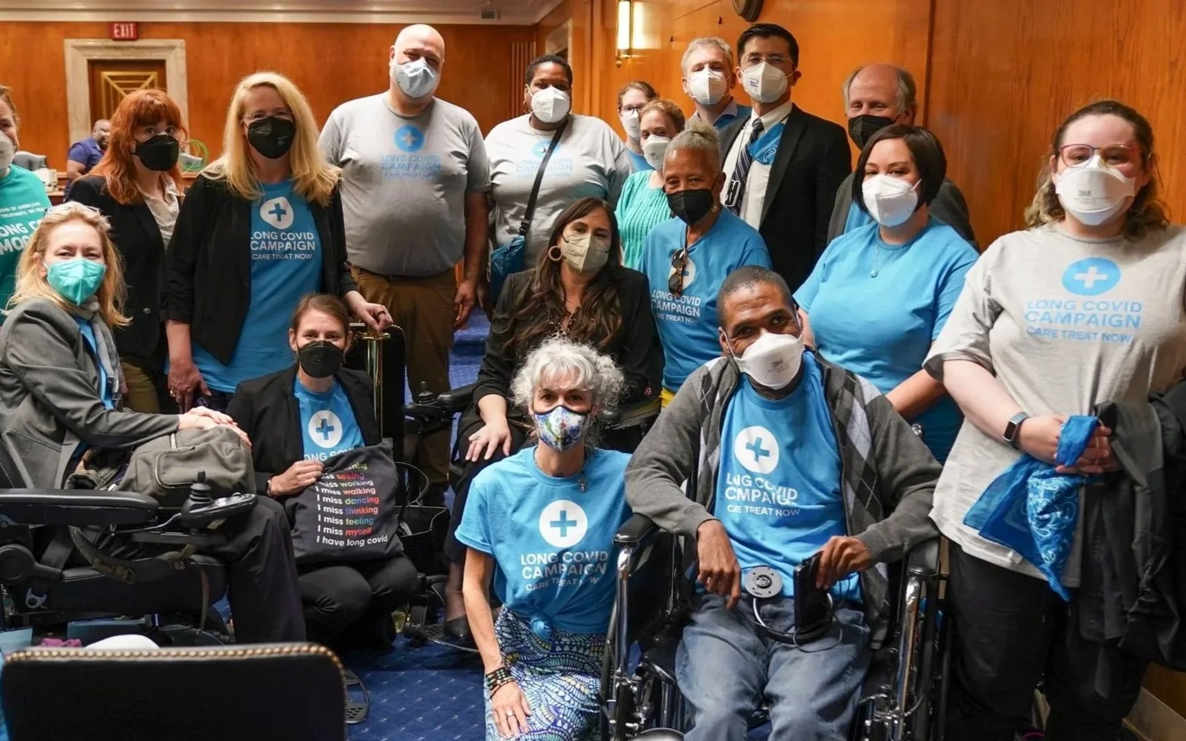 Photo of a masked, diverse group of chronically ill and disabled people part of LCC’s patient-advocate delegation at a key NIH Senate funding hearing in Washington DC. They wear LCC t-shirts and several use wheelchairs and other mobility aids.