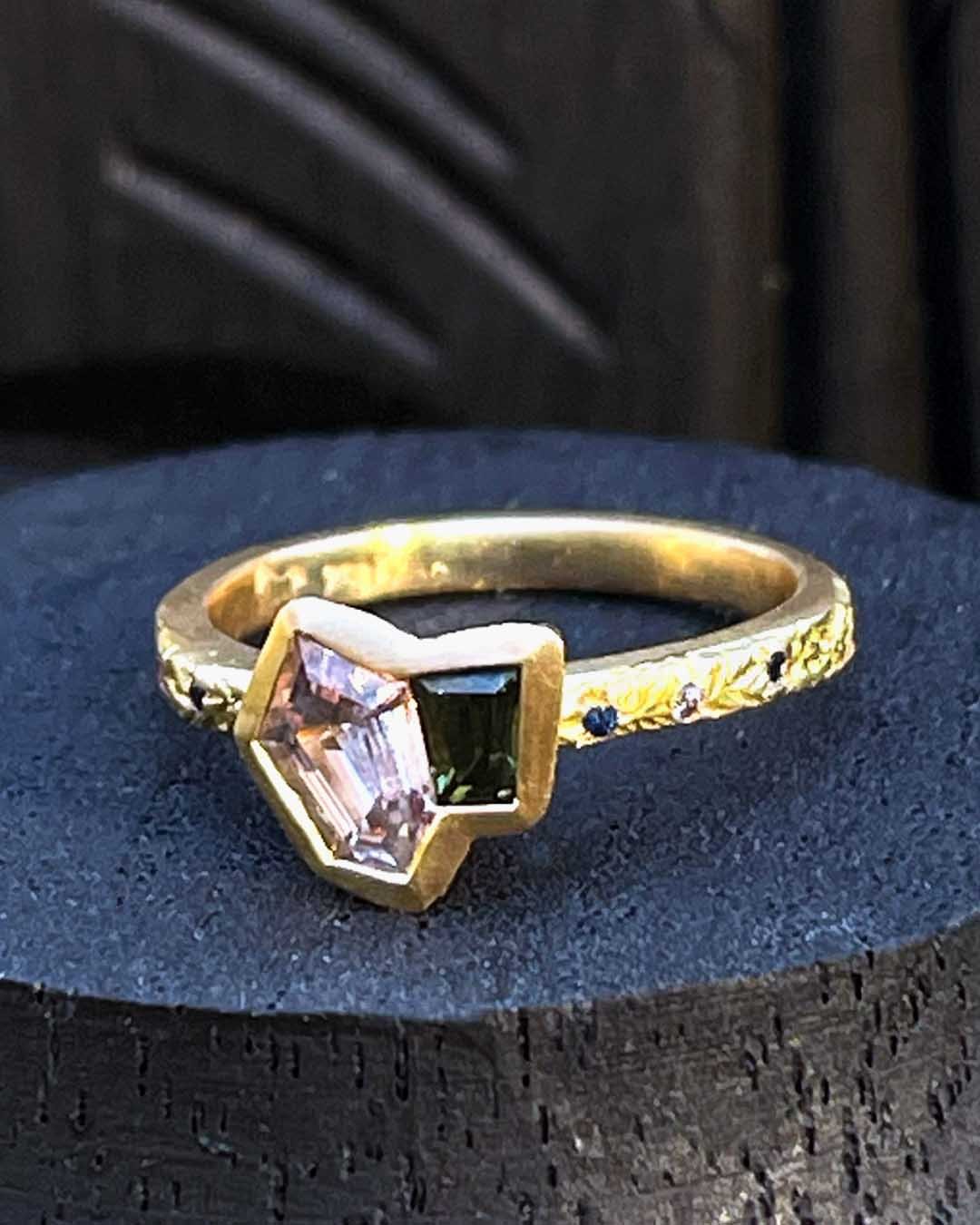 A hand made ring by Georgie Brooks featuring a hand cut Montana Sapphire and an Australian Sapphire in recycled 18ct Yellow Gold