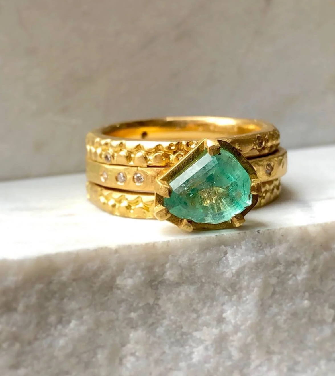 A gold and emerald engagement ring by georgie brooks