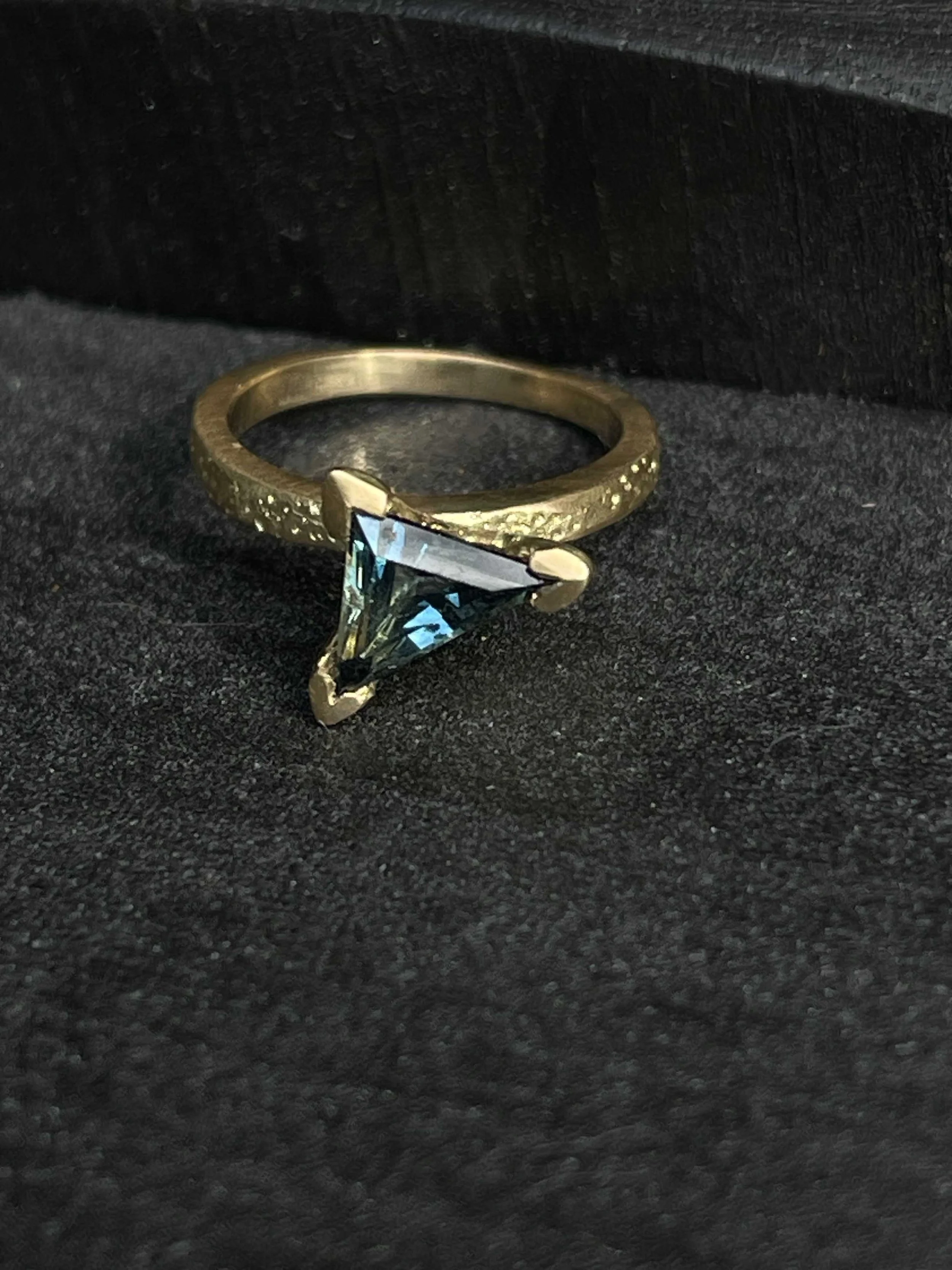 A hand cut Australian Sapphire designed by Georgie Brooks with recycled yellow gold