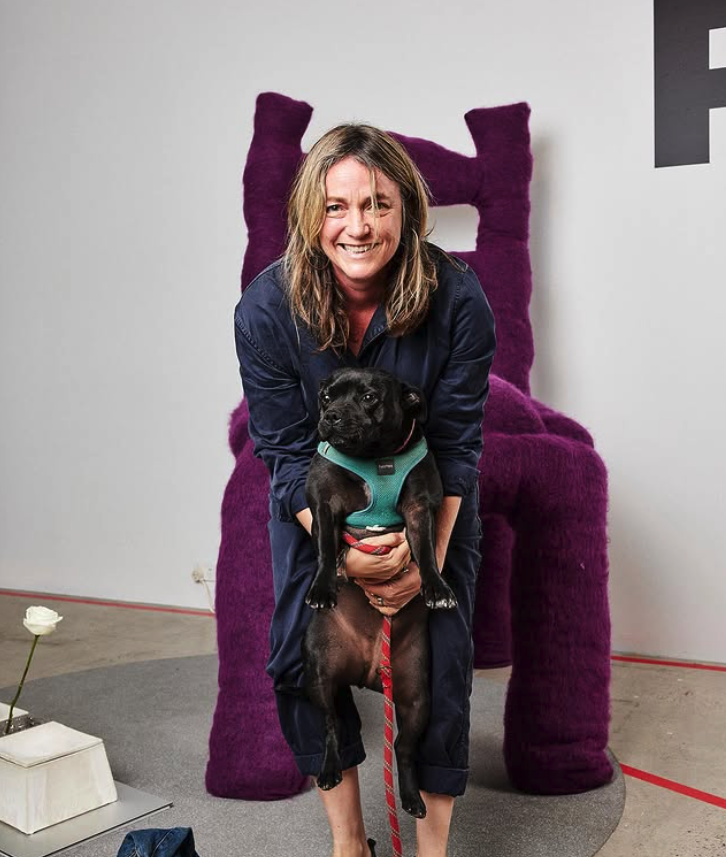 phote of founder Georgie Brooks with her black staffie Peanut
