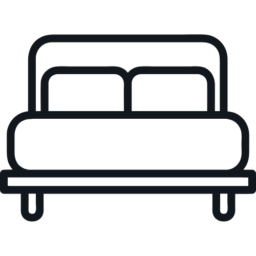 Icon of a bed with two pillows, a headboard, and a bed frame.