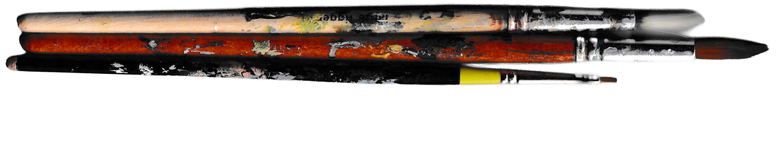 Close-up of several used paintbrushes with paint residue
