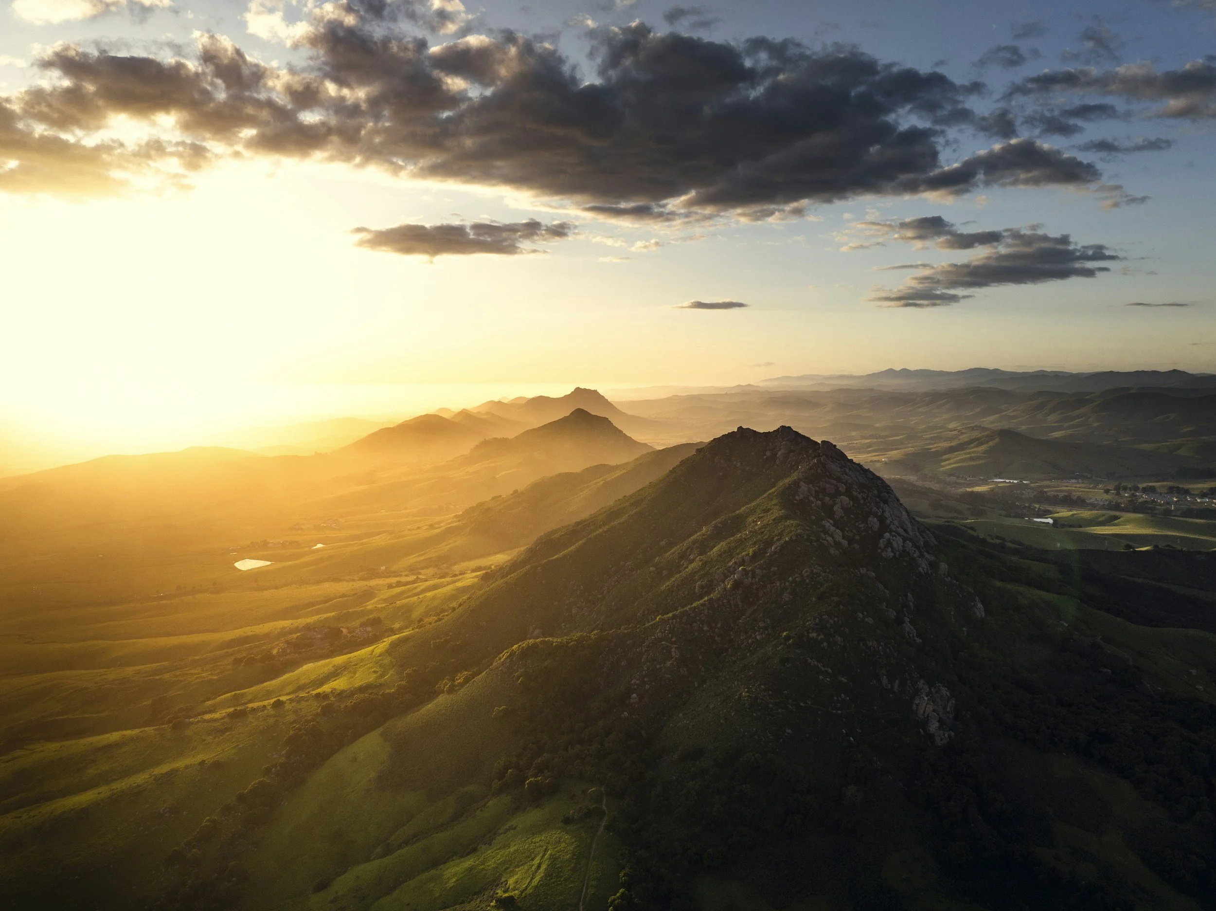 A landscape view of the seven sisters during sunset, with clouds scattered across the sky.