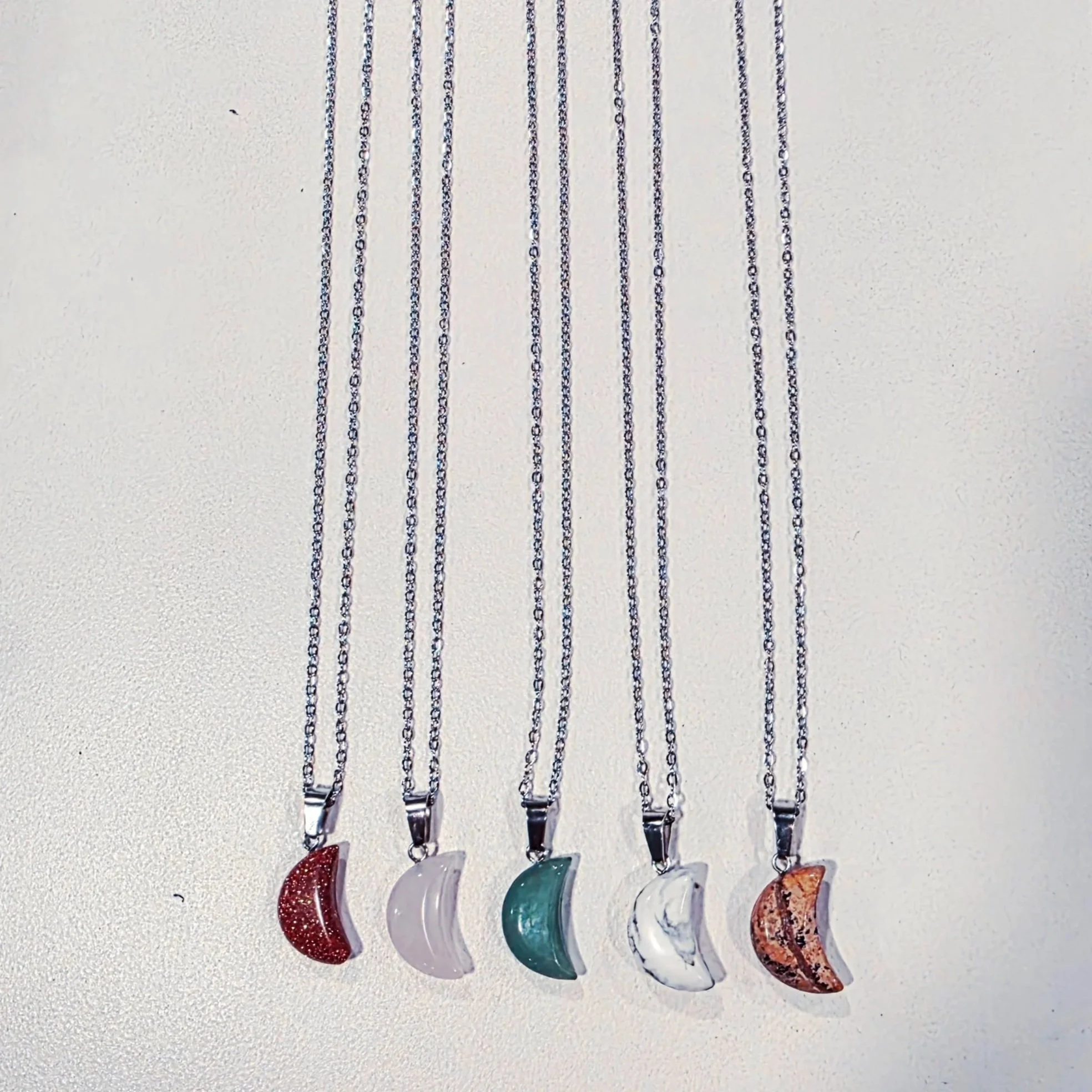 quartz and jasper moon pendants on necklaces
