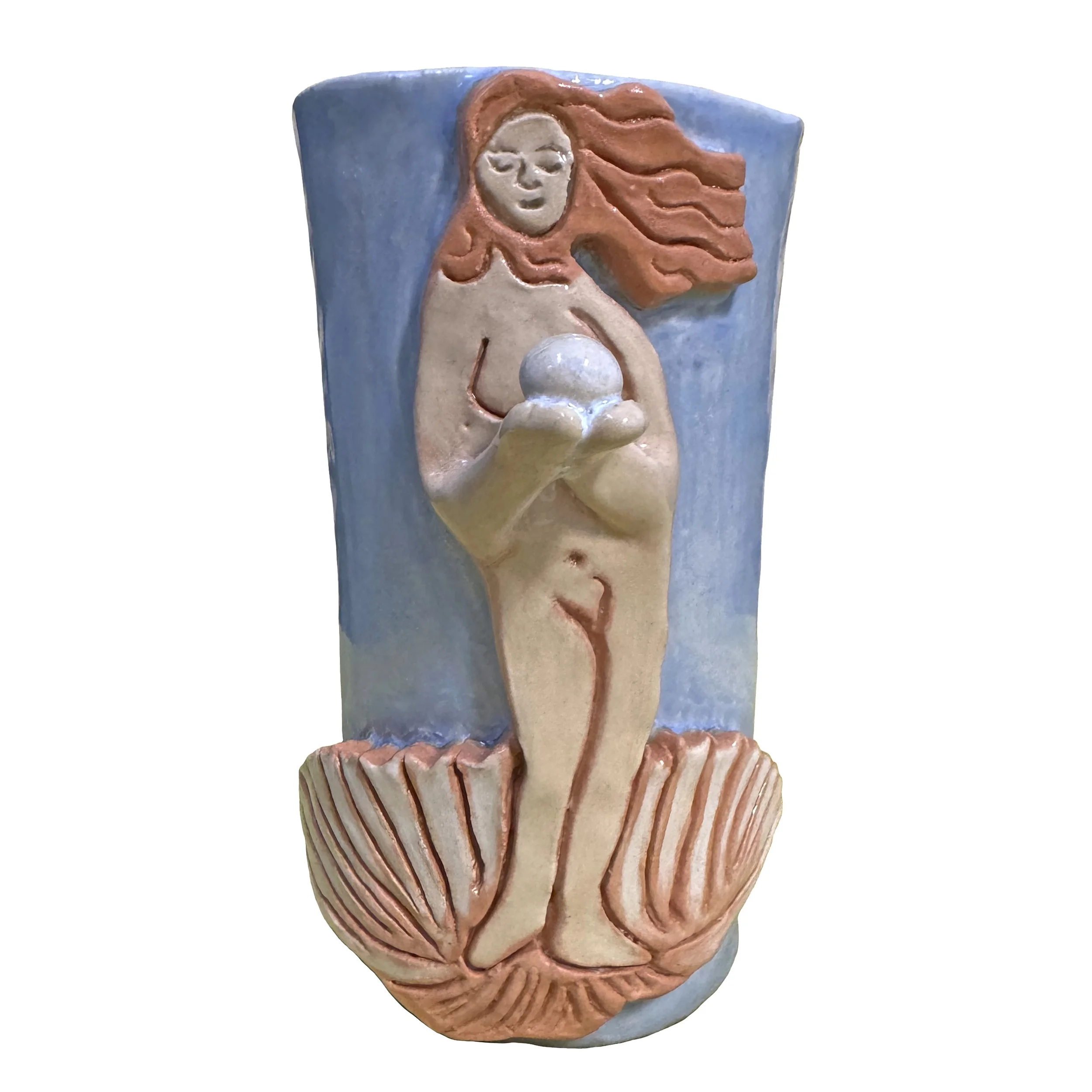 Ceramic cup featuring a nude figure standing on a shell with flowing hair, holding a sphere, with stylized anatomical features and a light blue background.