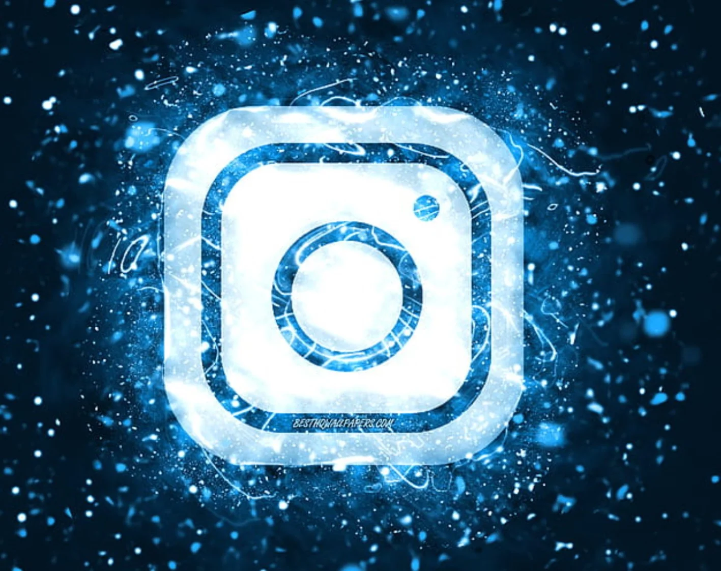 Digital explosion with a glowing white Instagram logo in the center, surrounded by blue particles and sparks.