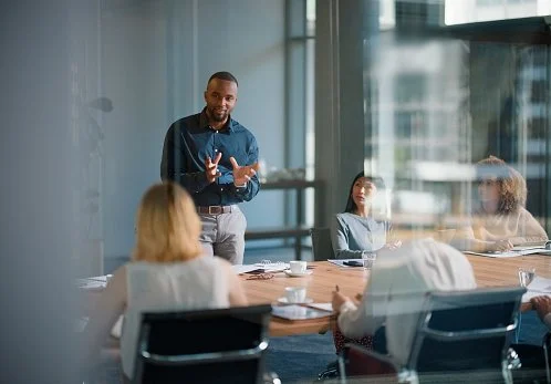 Business adviser leading a meeting with a client team