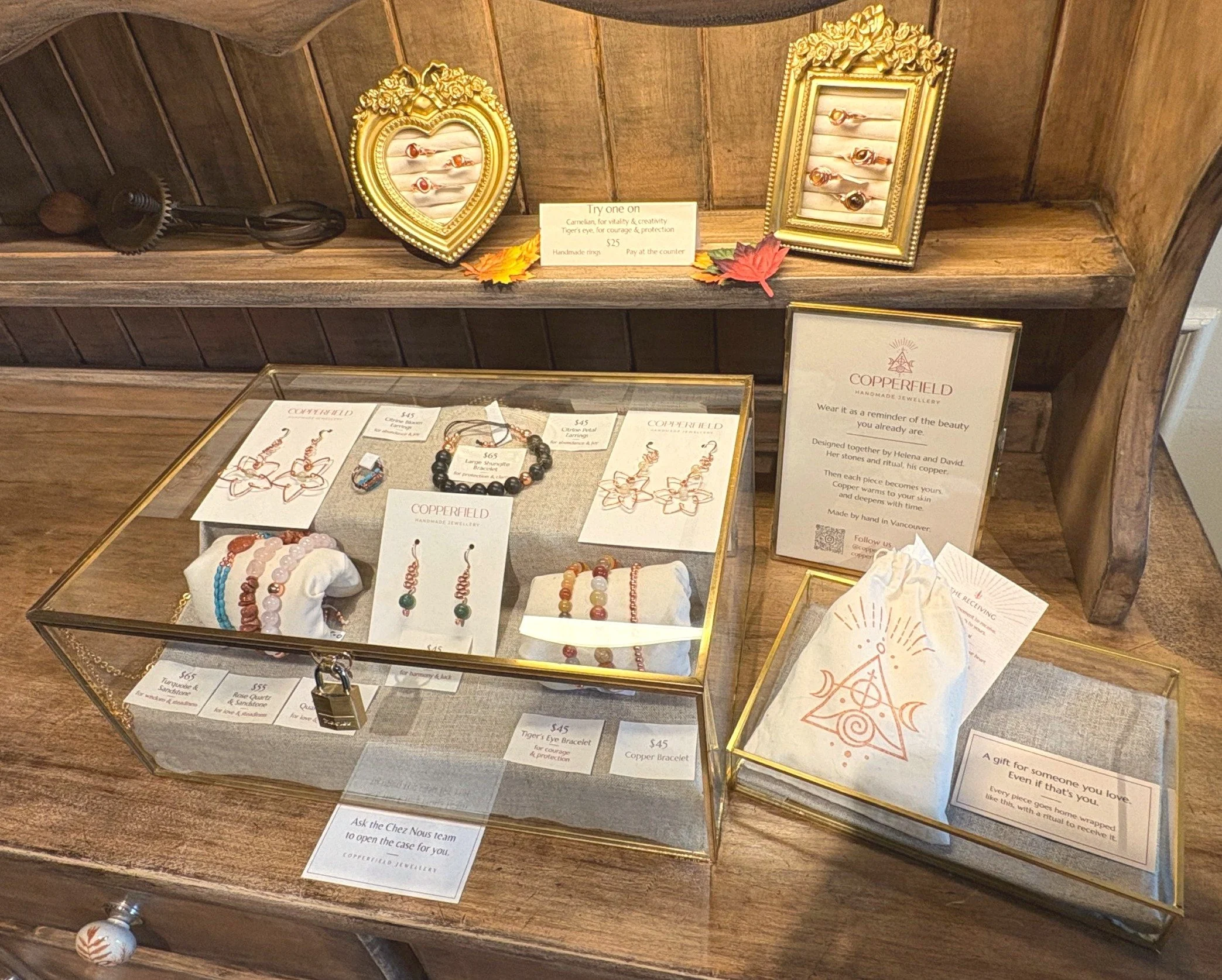 Copperfield Jewellery display at Chez Nous in Vancouver, with handmade copper rings, bracelets and earrings in a glass case