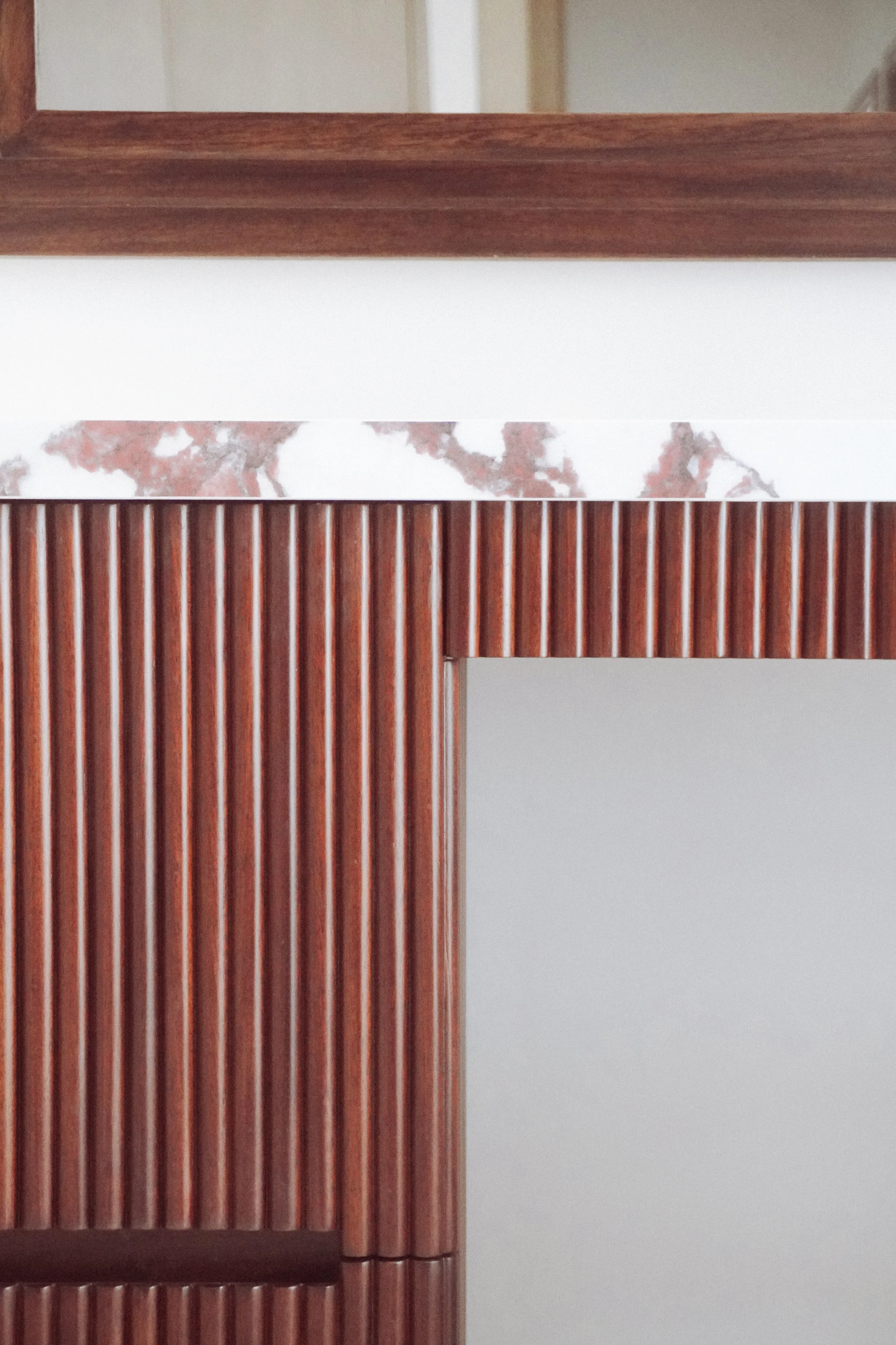 Close-up of fluted timber joinery with marble counter detail during bespoke manufacture