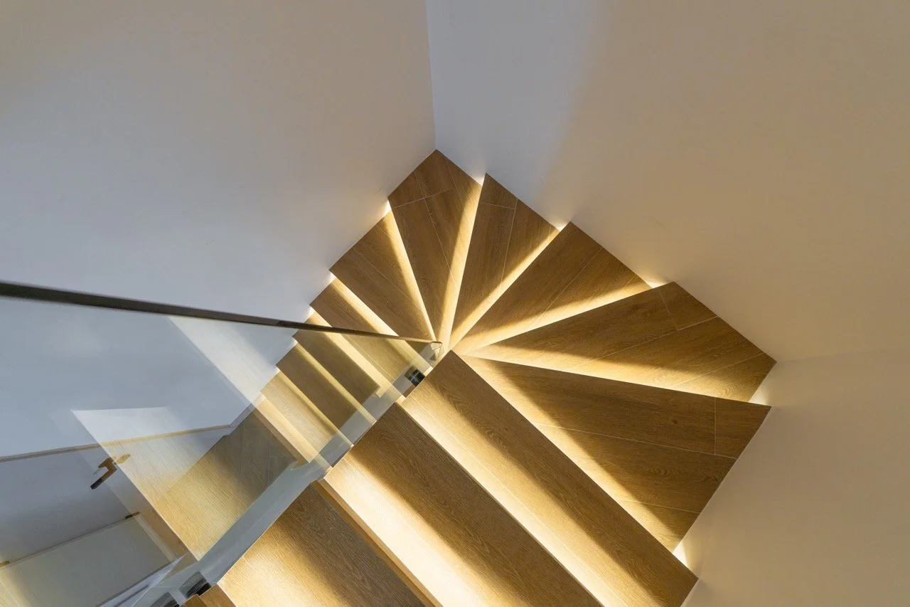 Timber staircase with integrated step lighting during a villa renovation.