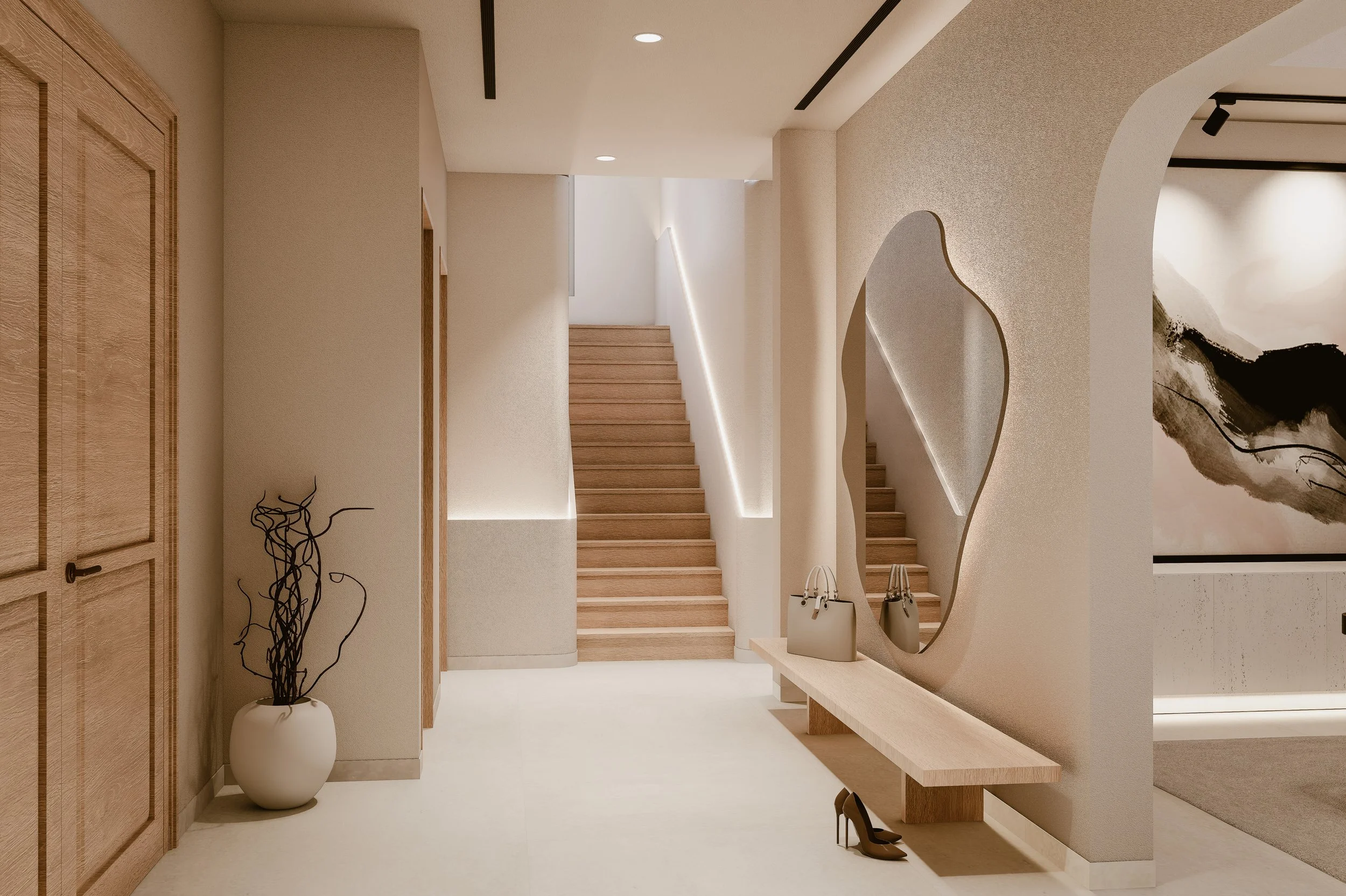 Sculptural villa staircase with curved wall mirror, integrated lighting and neutral interior finishes