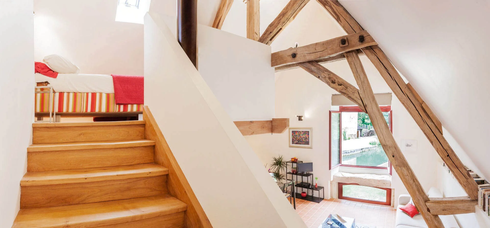 Wide shot of mezzanine bedroom and living space in gîte, Rix, Burgundy.