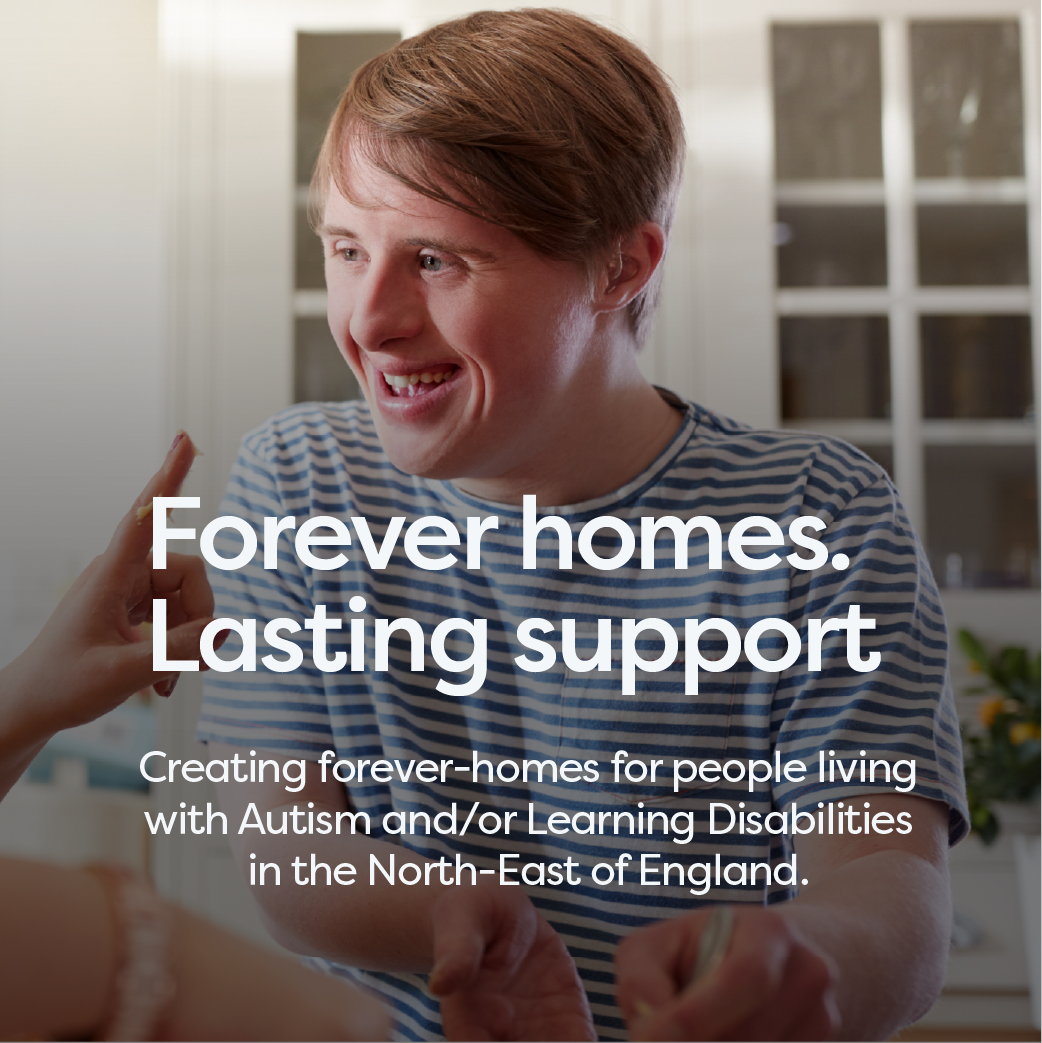 A young man with light brown hair smiling and talking, wearing a striped shirt, in a bright kitchen. Text on image: 'Forever homes. Lasting support. Creating forever-homes for people living with Autism and/or Learning Disabilities in the North-East of England.'.