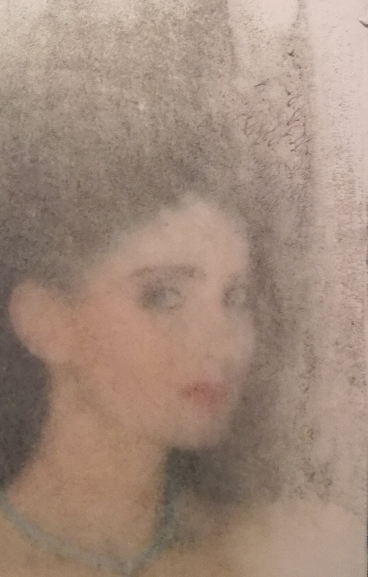 Blurred photo of a woman with dark hair and light skin, looking sideways, with an abstract background.