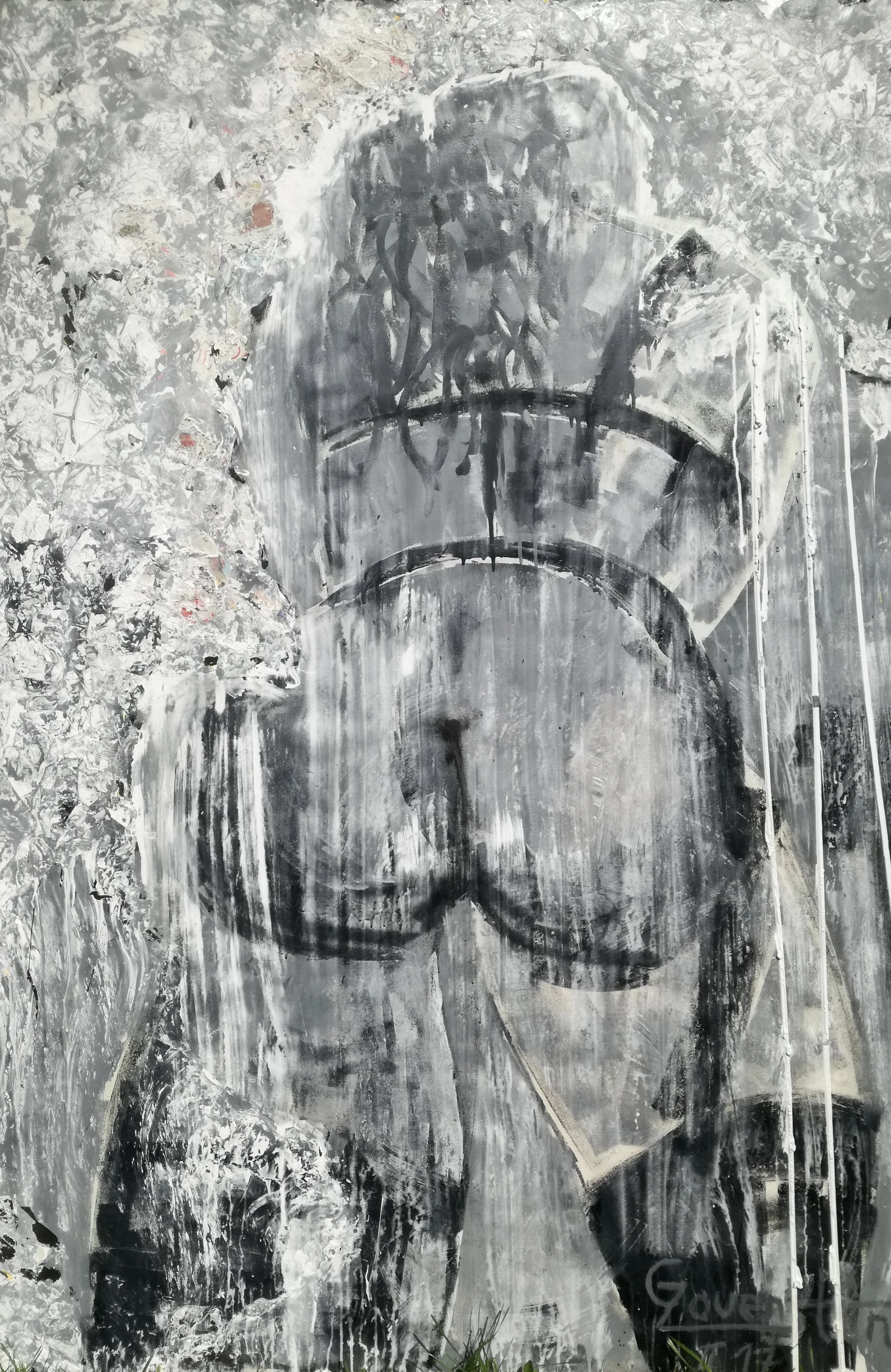 A black and white graffiti portrait of a woman with curly hair, looking to the side, painted on a textured wall.